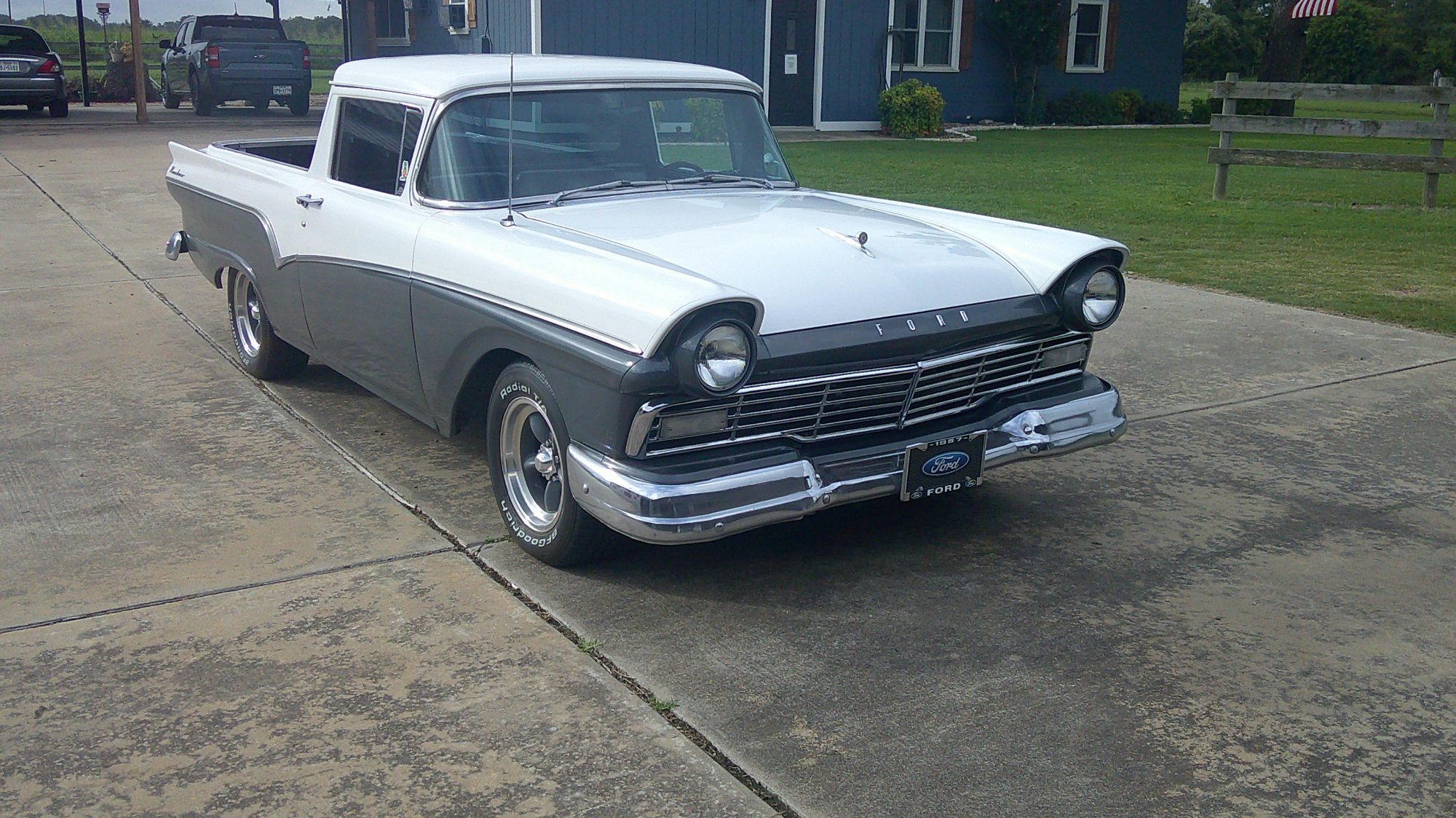 Front three-quarter view of a white and gray 1957 Ford Ranchero.