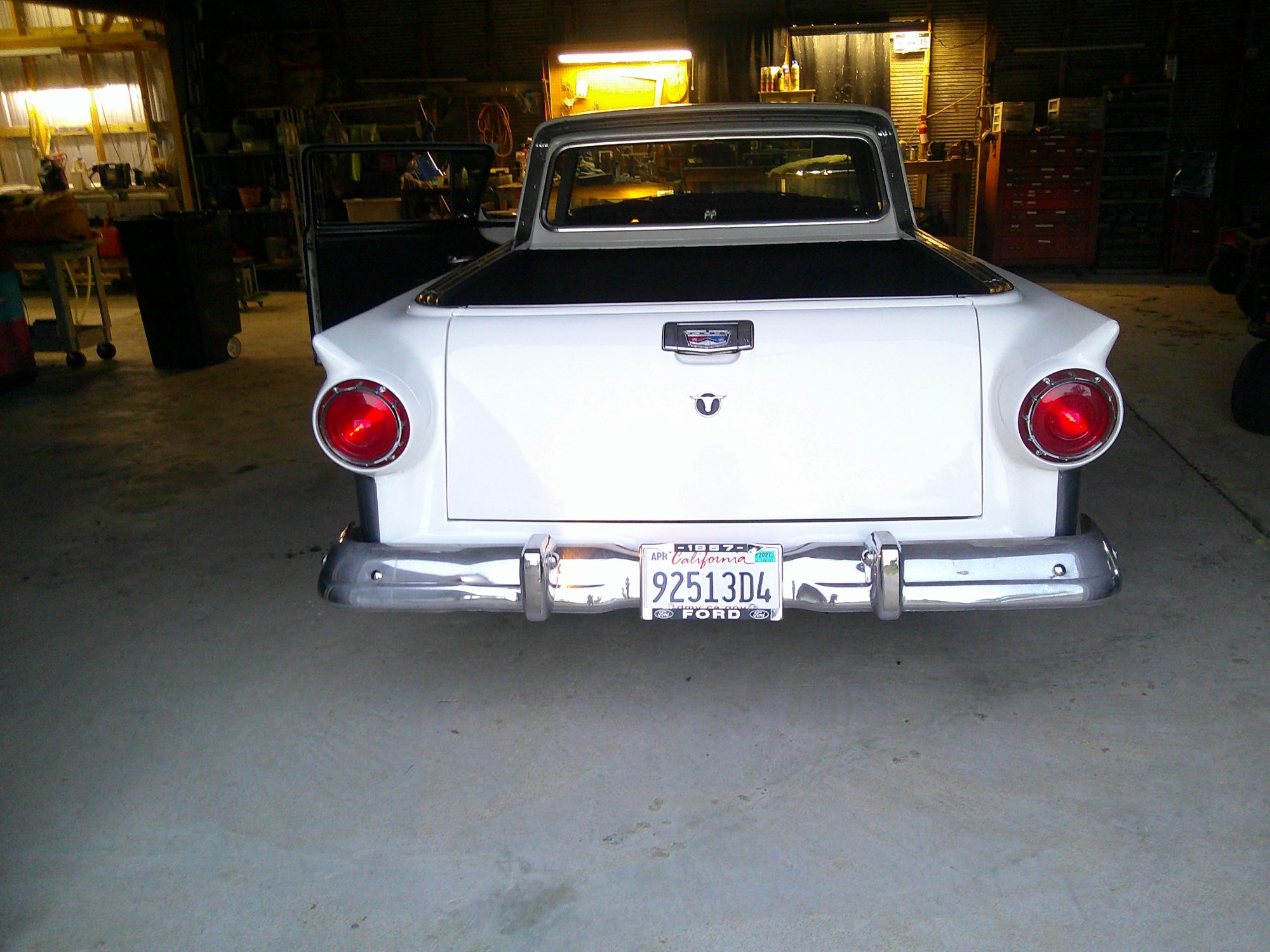 Rear view of white 1957 Ford Ranchero in garage