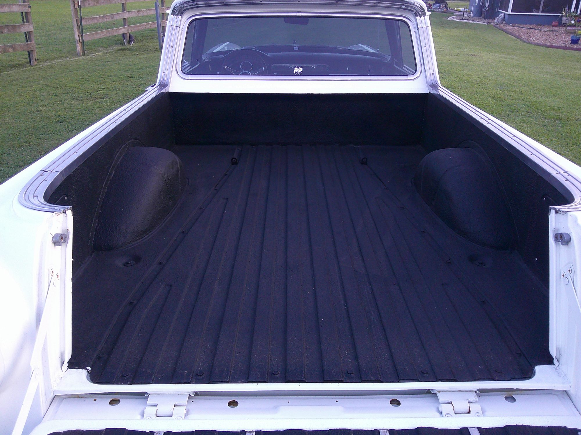 Rear view looking into the truck bed with black liner.