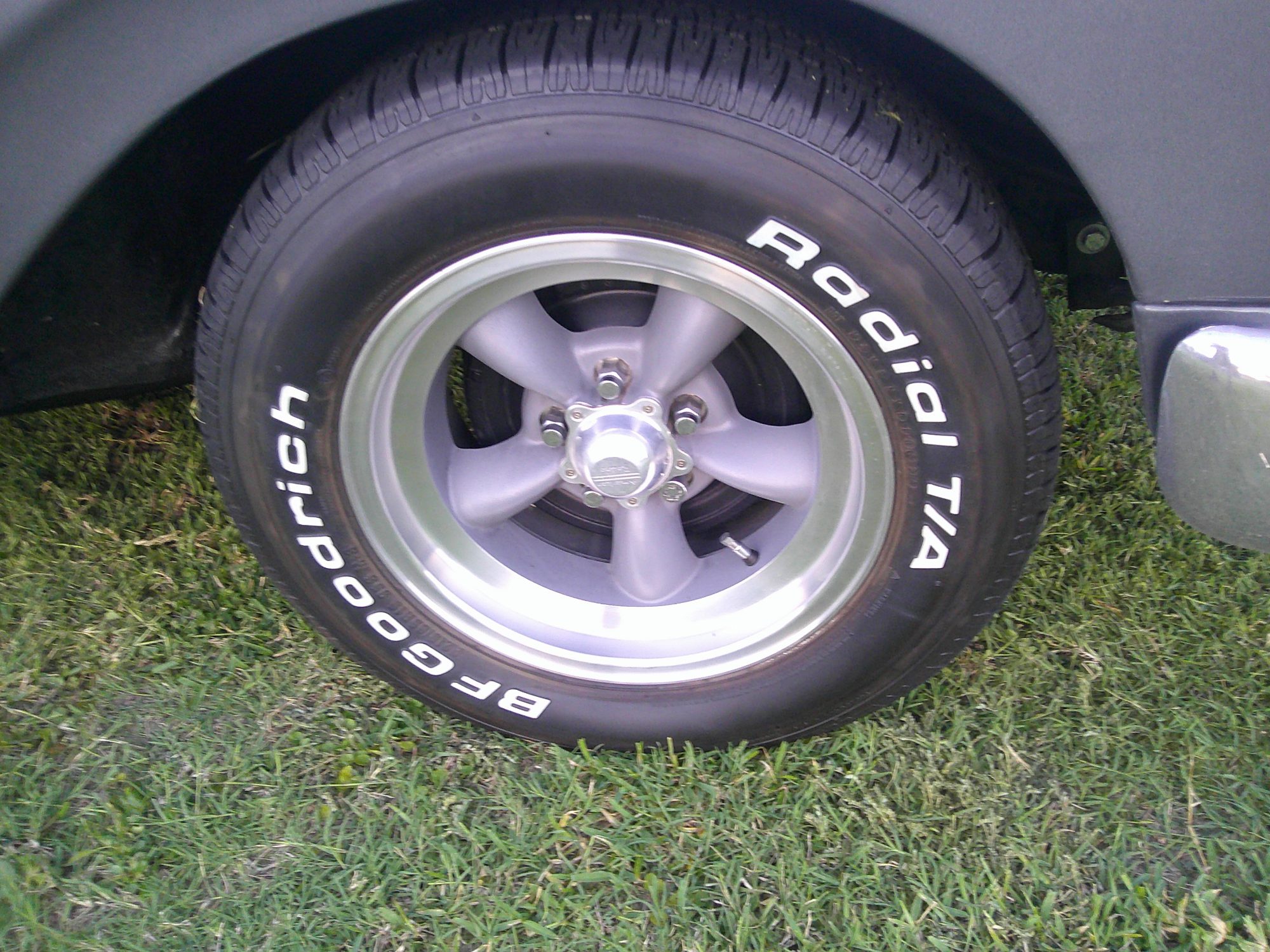 Close-up of five-spoke alloy wheel with BFGoodrich Radial T/A tire.