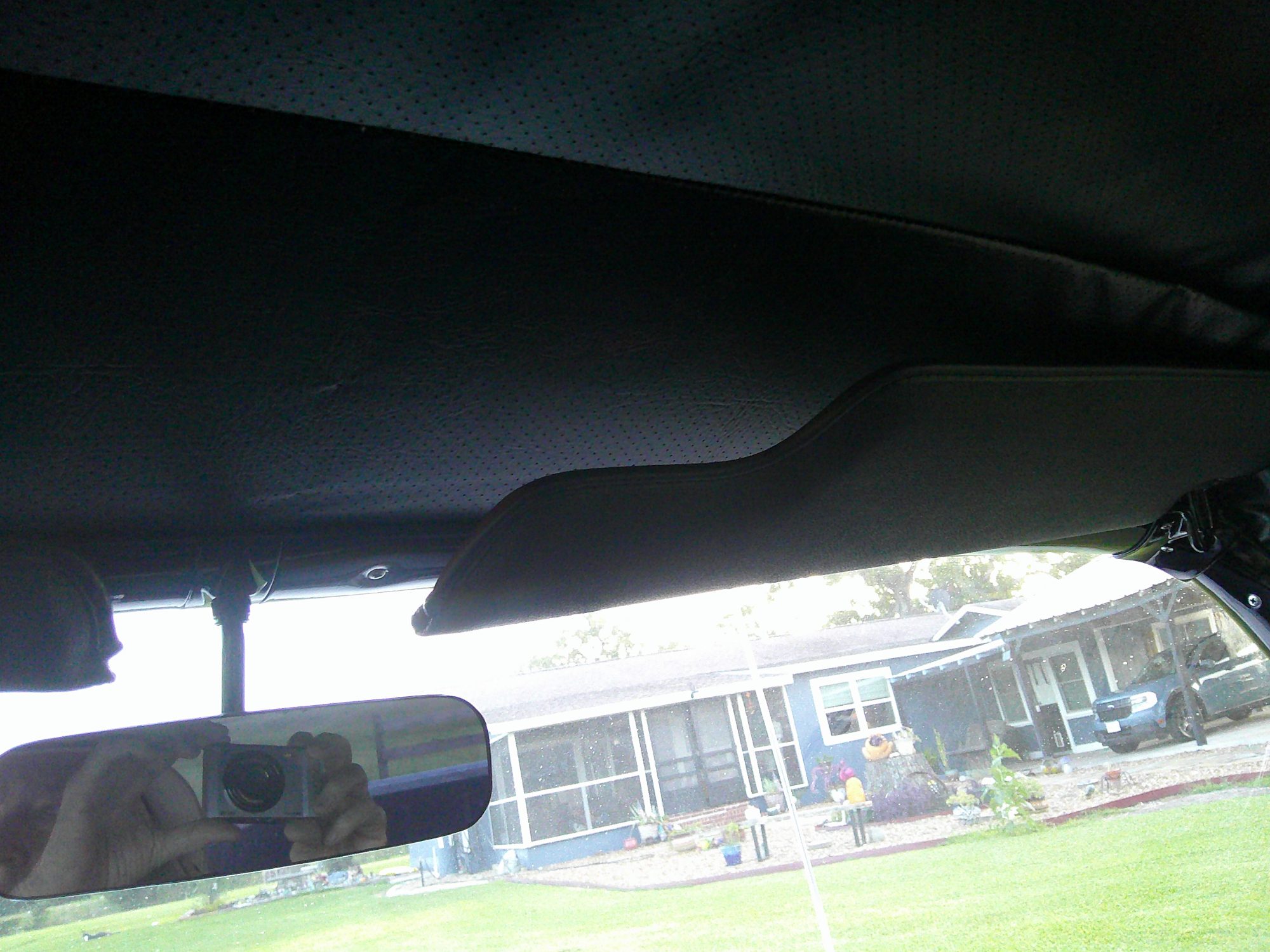Interior view of headliner, sun visor, and rearview mirror.