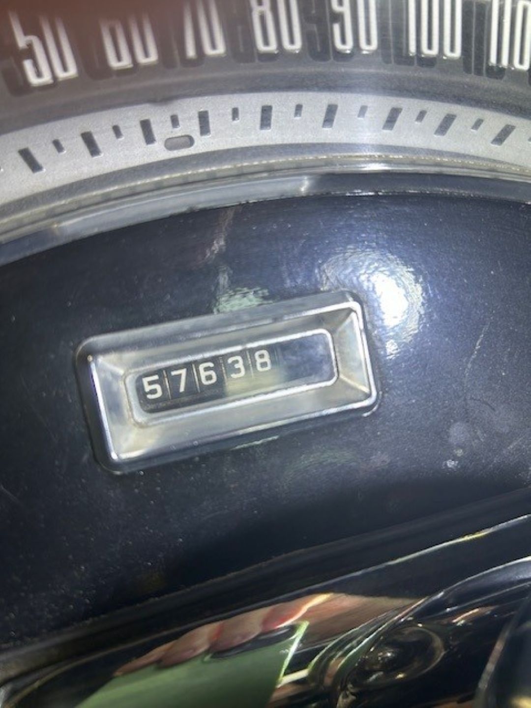 Close-up of the mechanical odometer showing 57,638 miles.