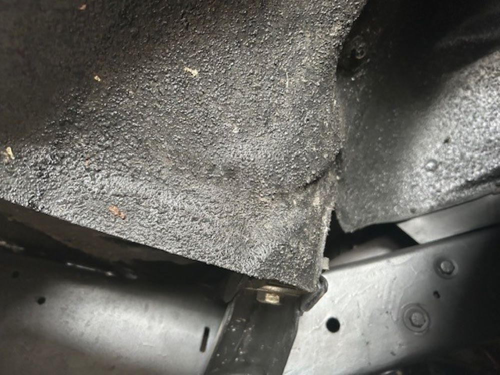 Close-up of underbody coating and chassis frame section.