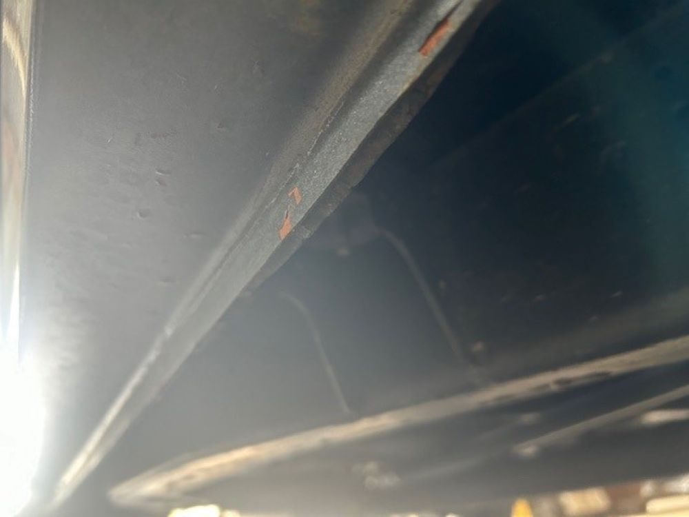 Underside view showing chassis frame rail and floor pan