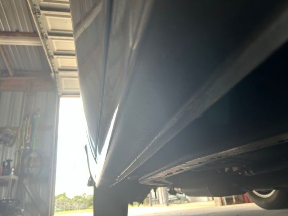Low-angle shot showing rocker panel and frame rail condition.