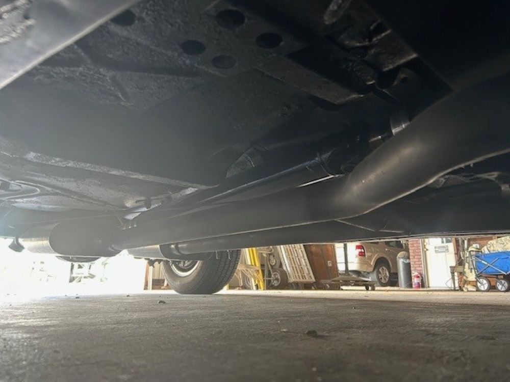 Undercarriage view showing exhaust system and floor pans.