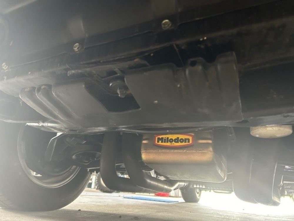 Underbody view showing Milodon oil pan and exhaust headers.