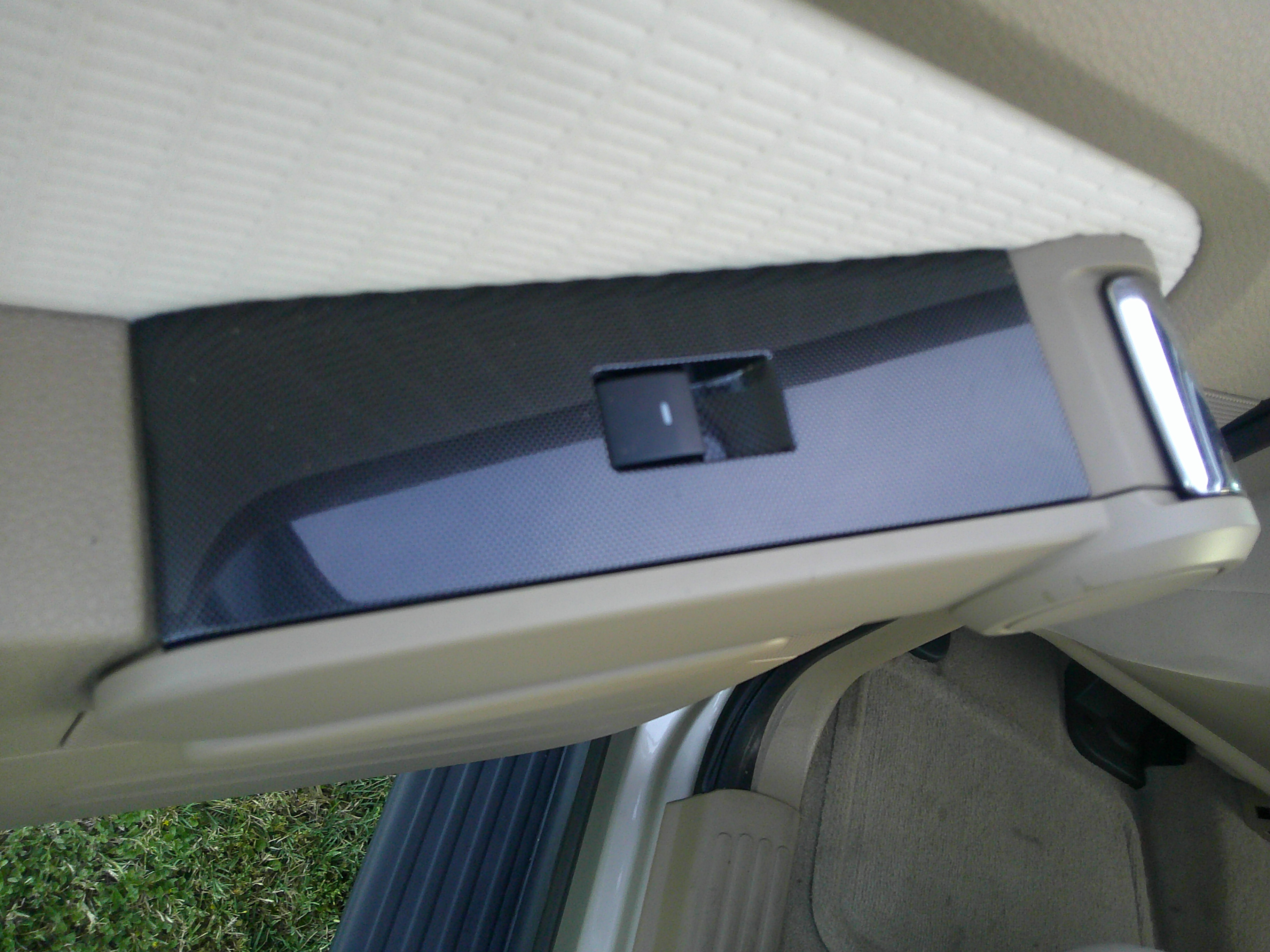 Passenger side door armrest with power window switch.