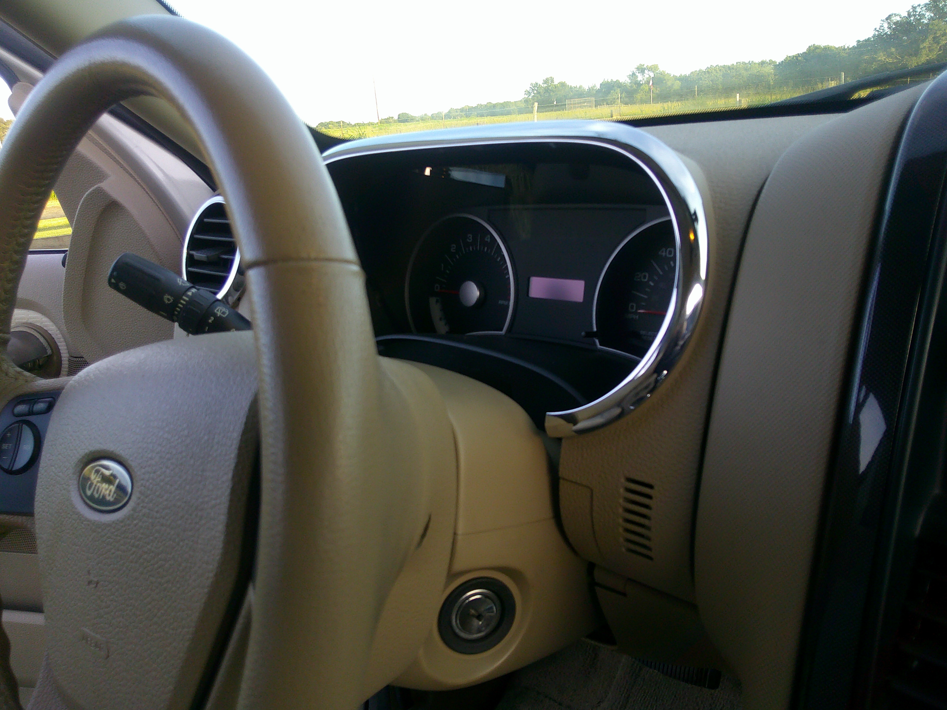 Driver side perspective showing steering wheel and instrument cluster