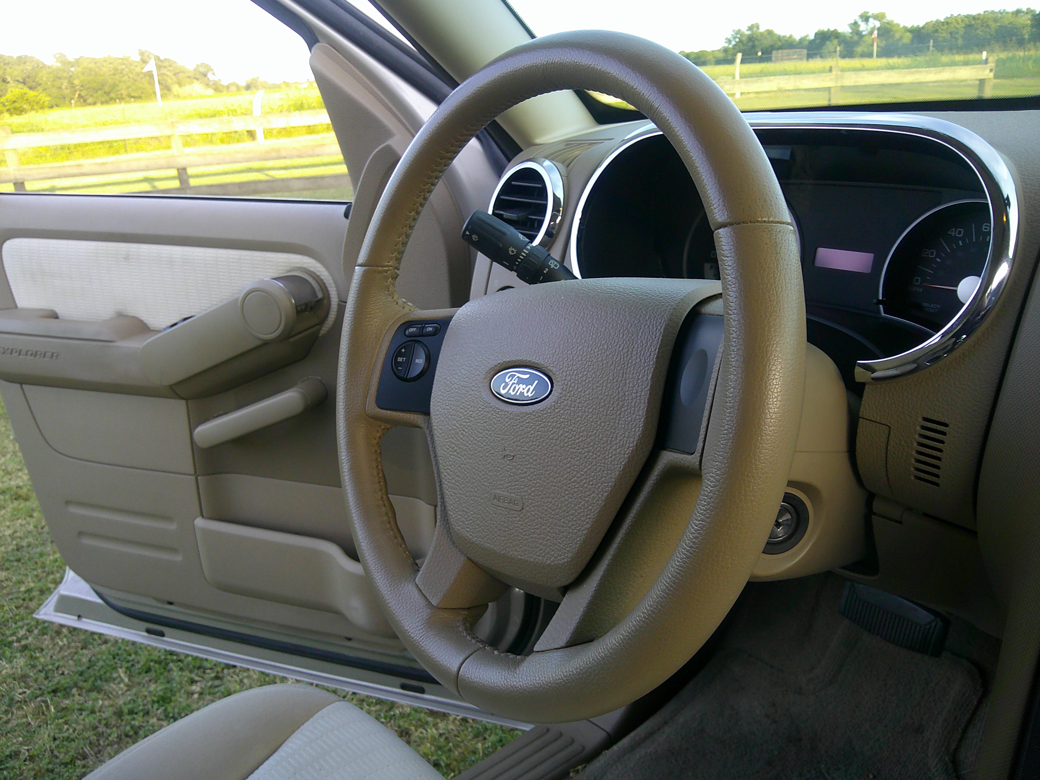 Ford steering wheel and dashboard view from open driver side door