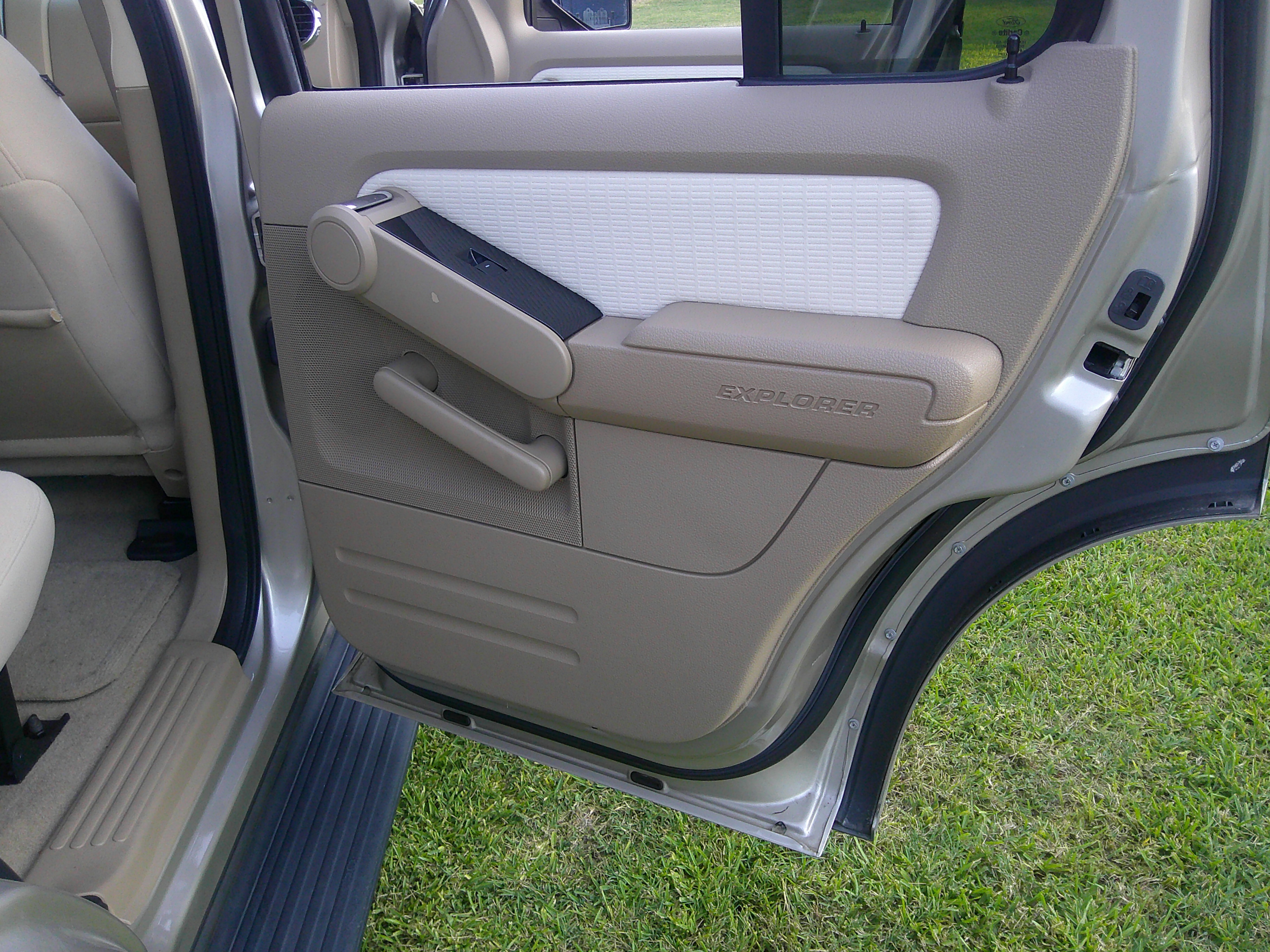 Rear interior passenger door panel with Explorer badging.