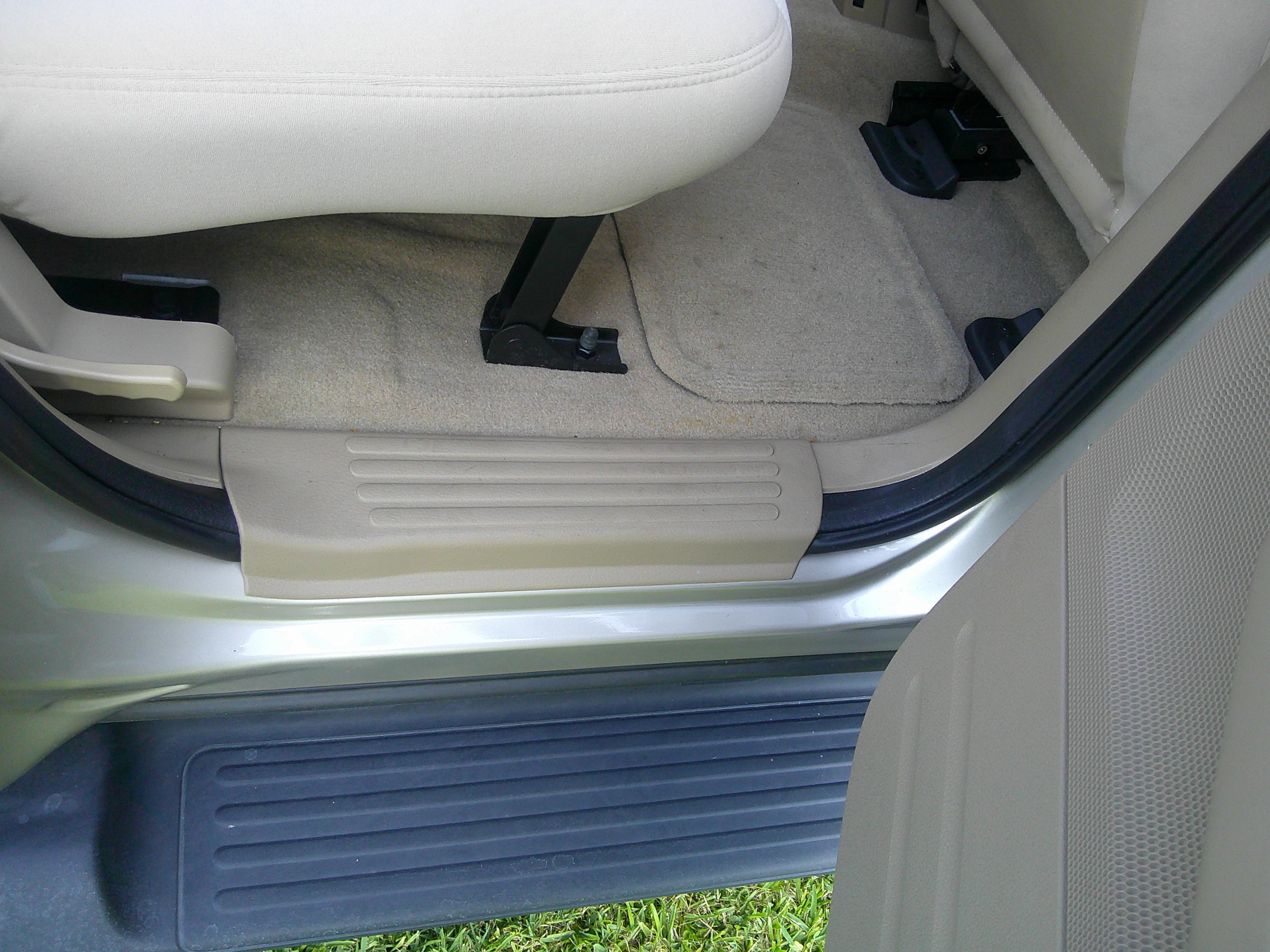 View of the floor board, door sill, and running board by the rear seat.