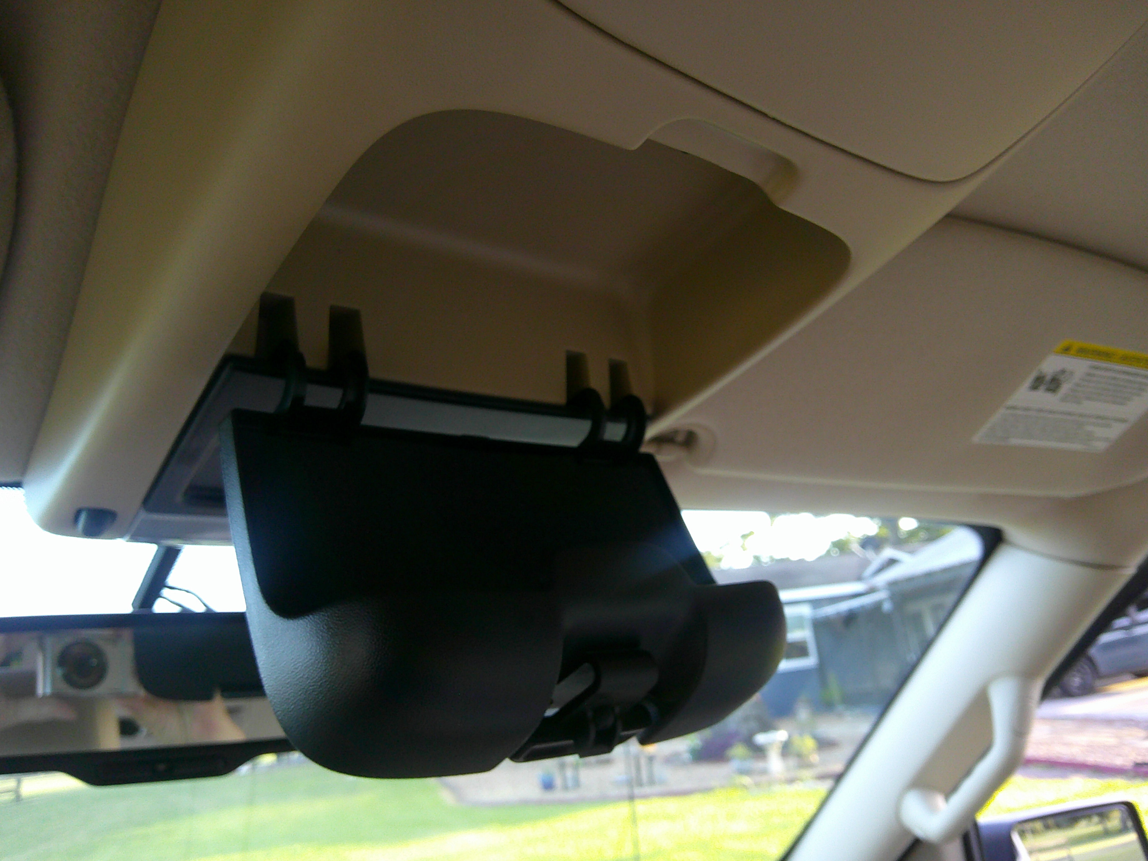 View of the overhead sunglasses storage compartment in the open position.