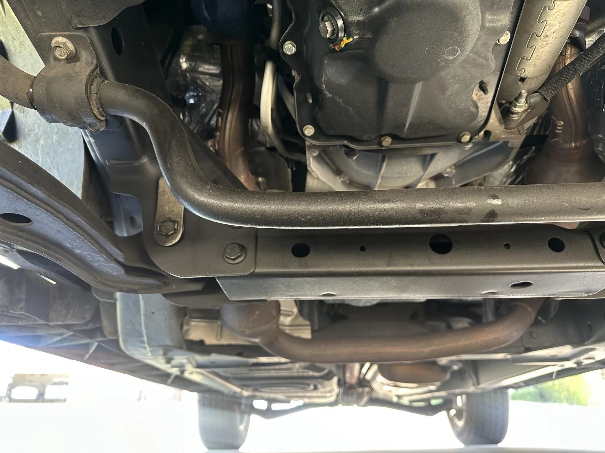 Undercarriage view showing chassis, sway bar, and oil pan