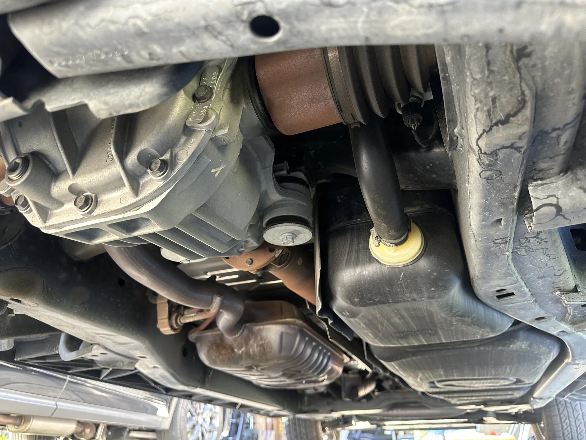 Underbody view showing differential, exhaust components, and fuel tank.