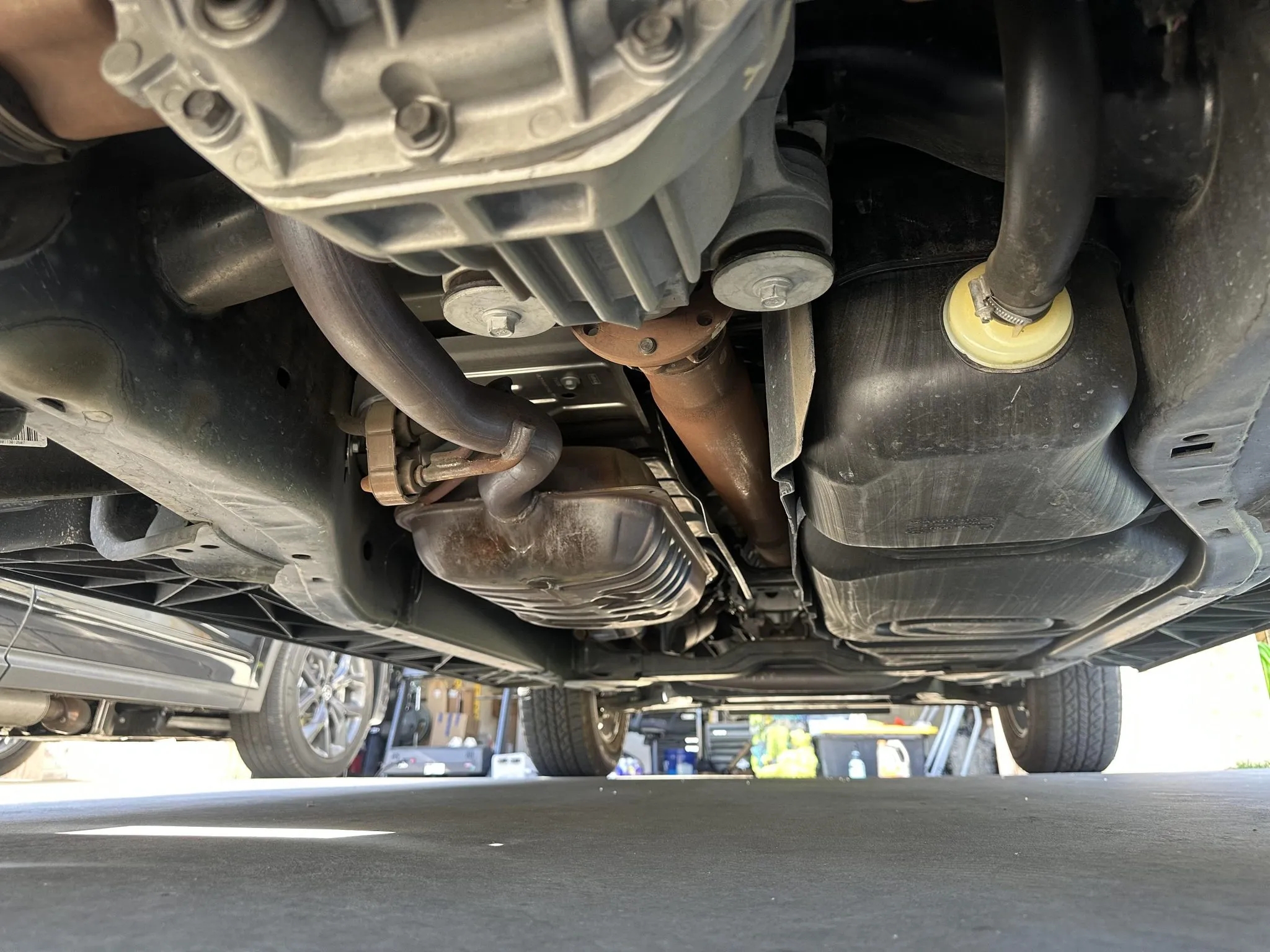 Undercarriage view showing exhaust system, driveshaft, and rear differential.