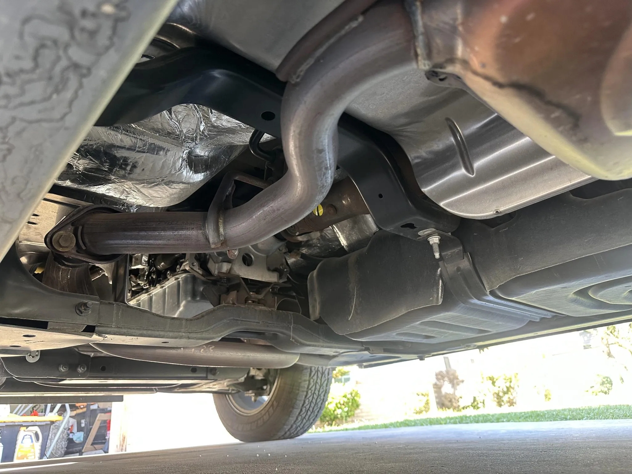 Underbody view showing the exhaust system, chassis frame, and heat shielding.