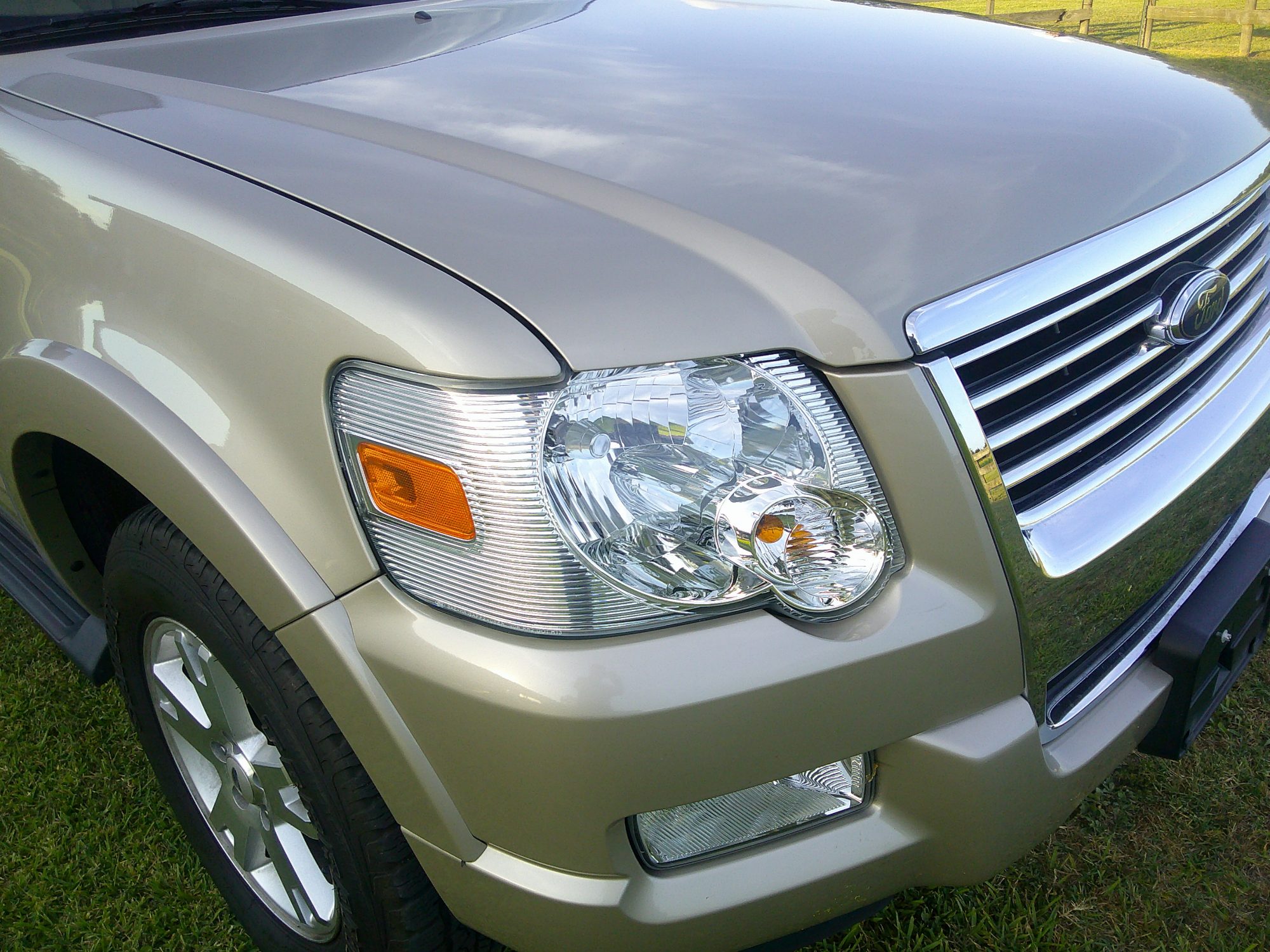 Close-up of front passenger side headlight and grille
