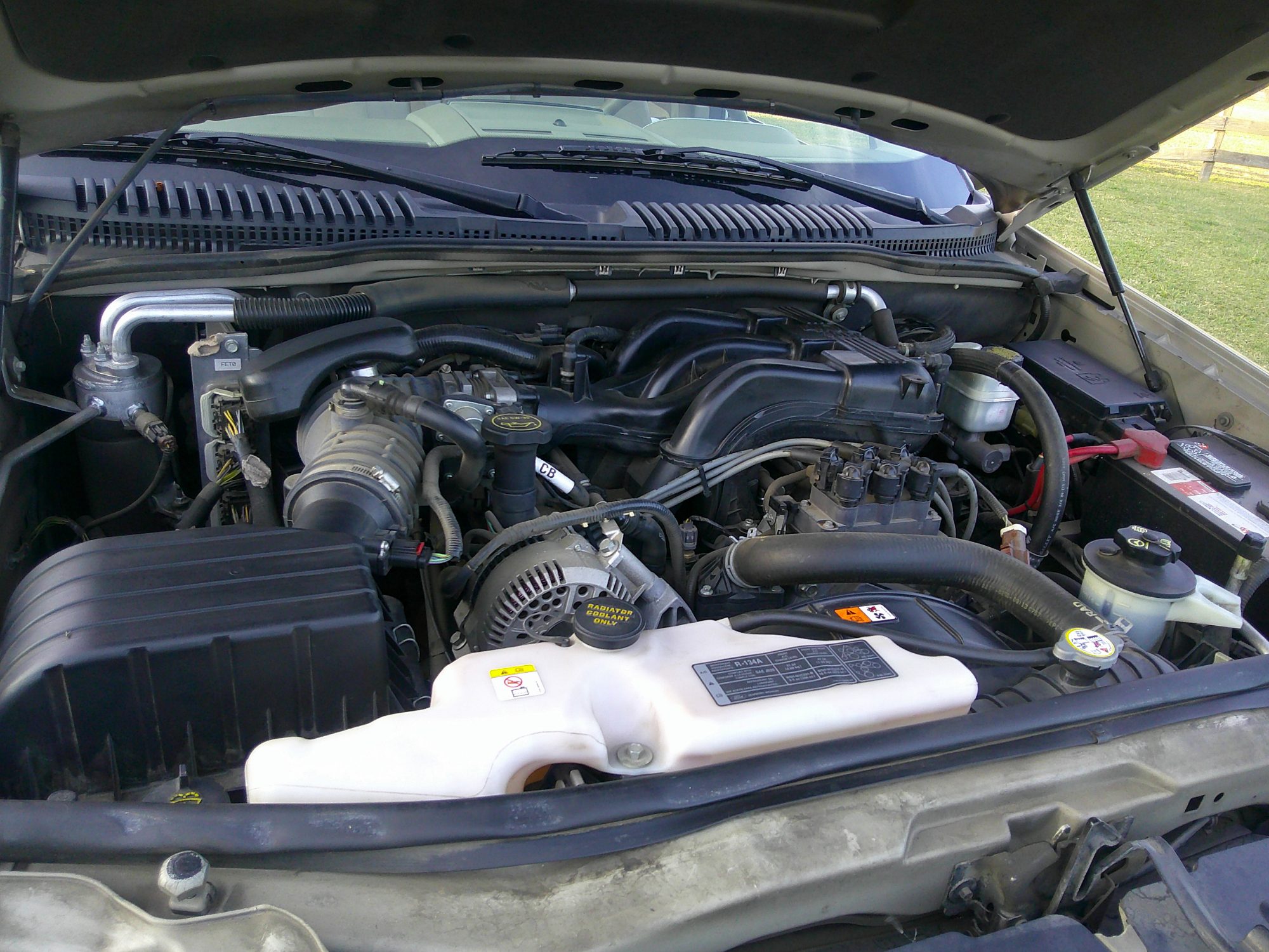Full view of the engine bay and components with the hood open.