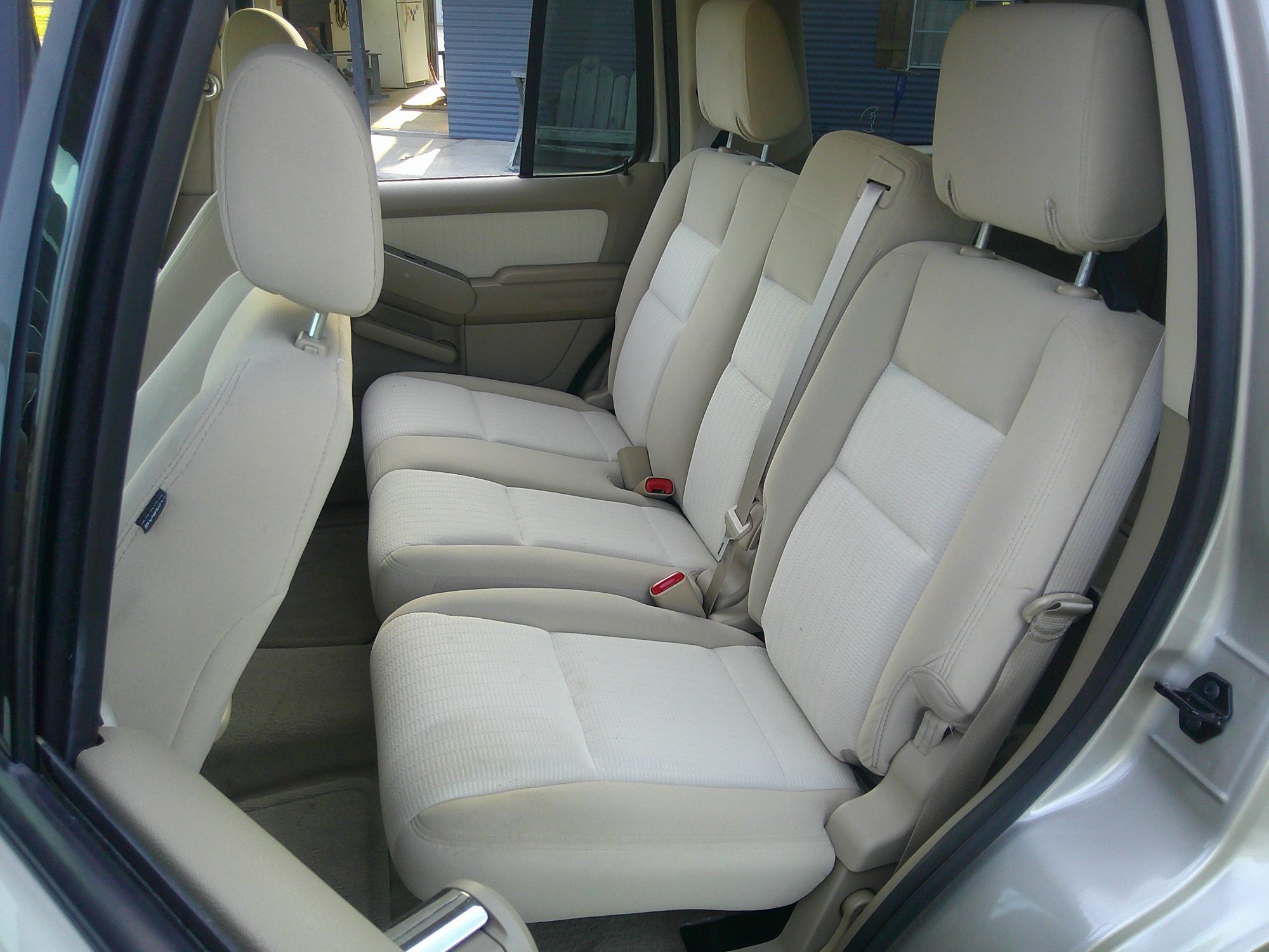 Rear passenger bench seating in beige cloth upholstery