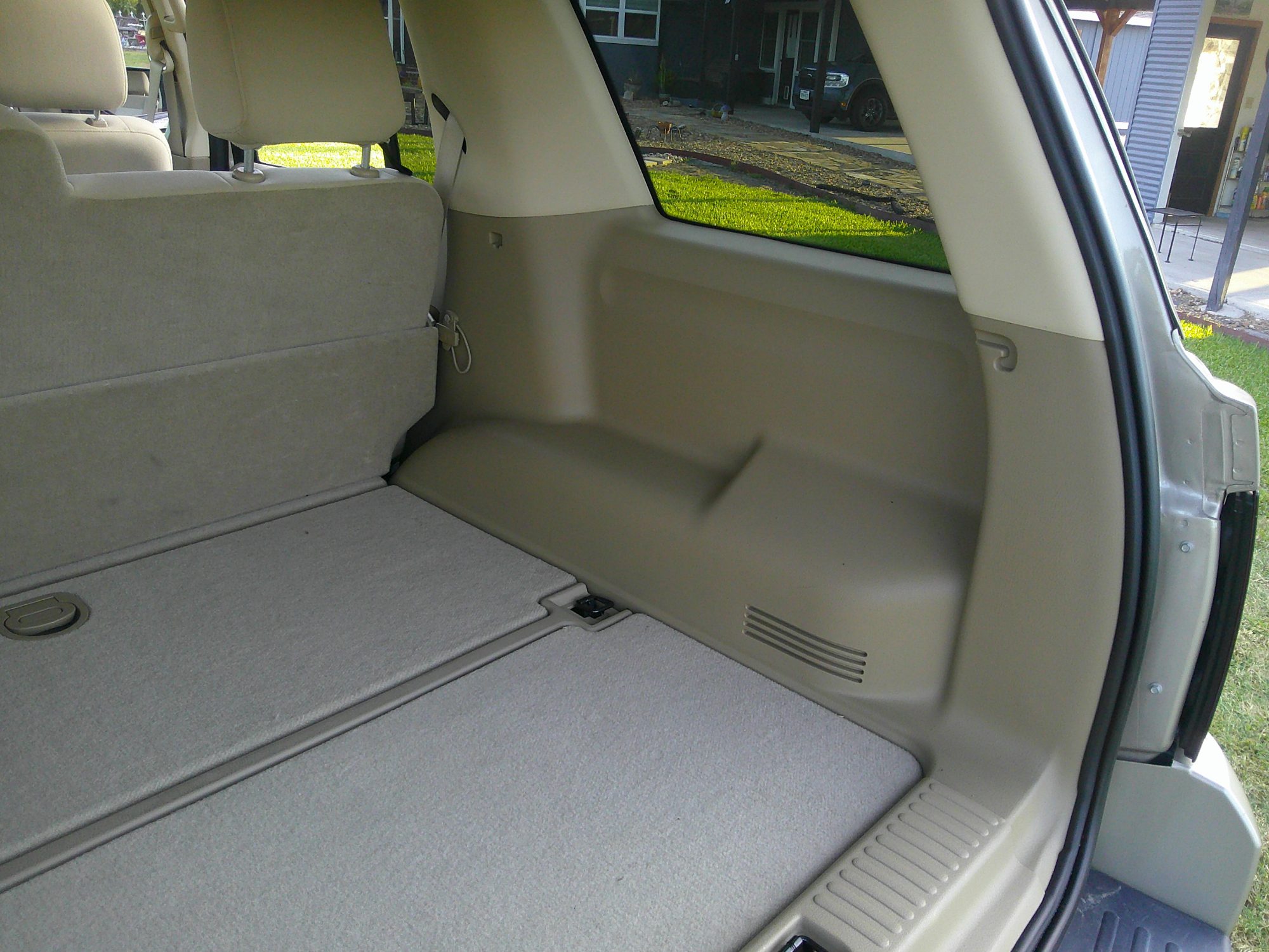 Rear cargo area and trim panels with folded seats