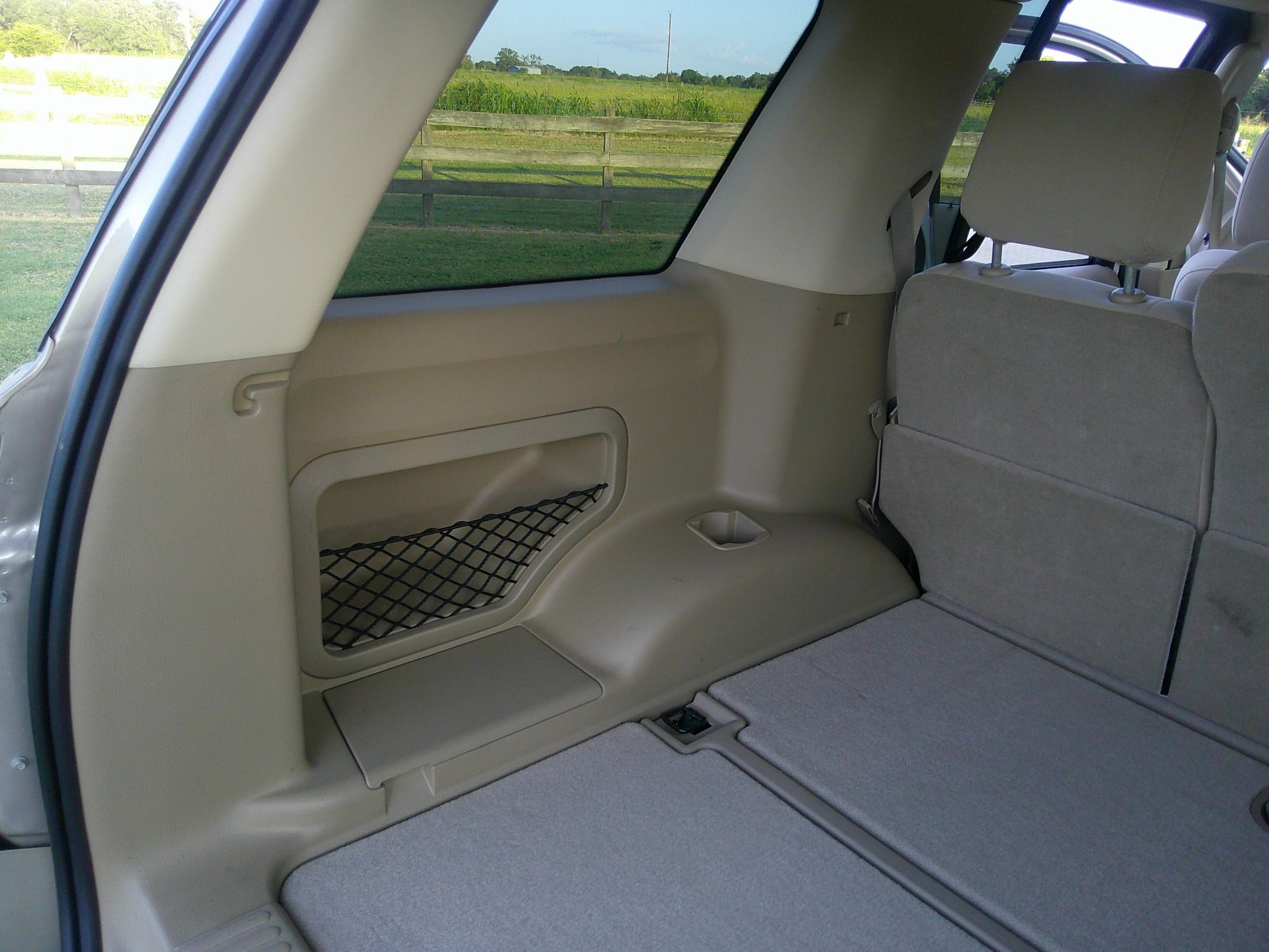 Rear cargo area and folded third-row seating with storage net