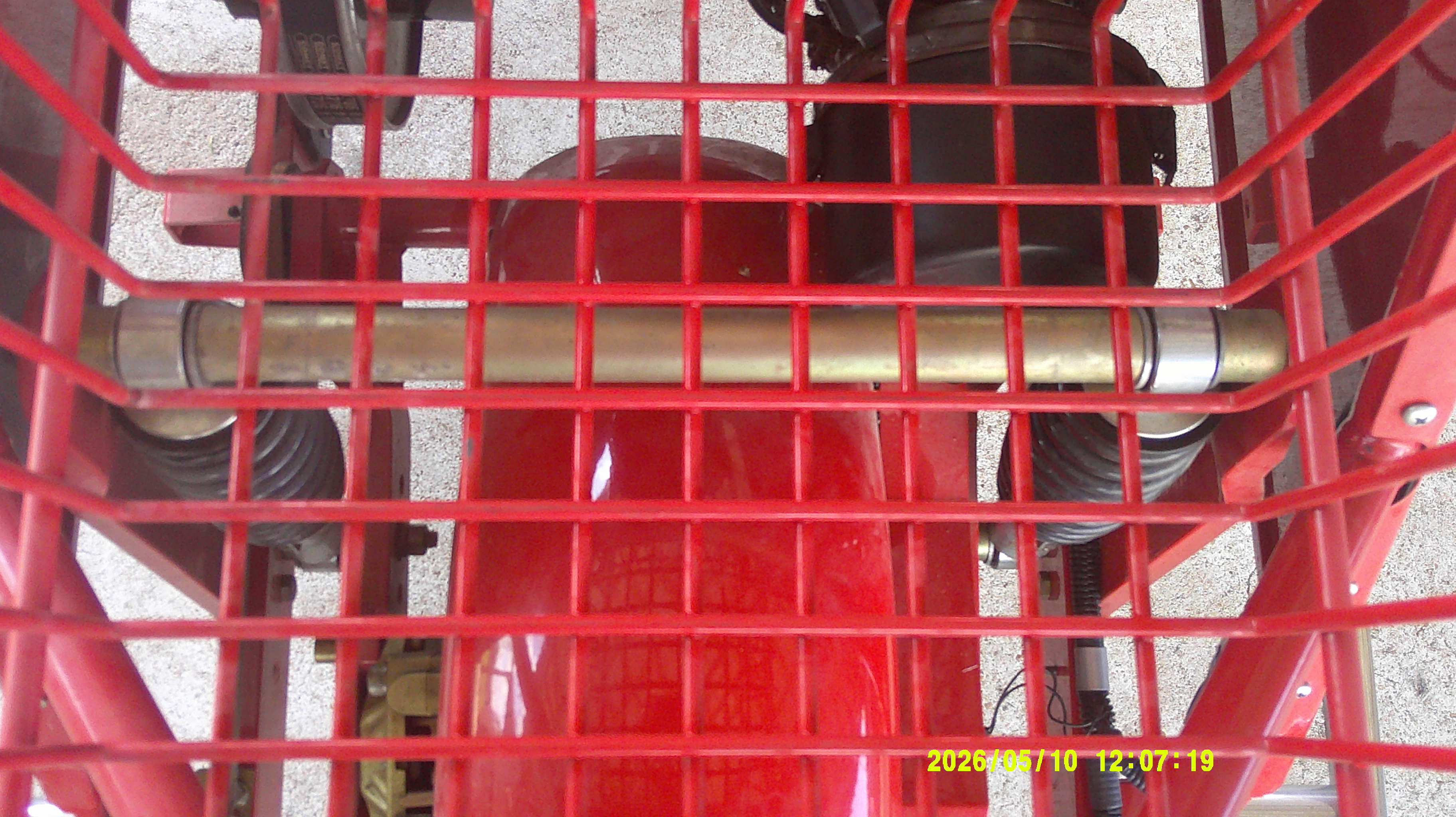 Top-down view of the rear suspension and axle through the red storage rack.