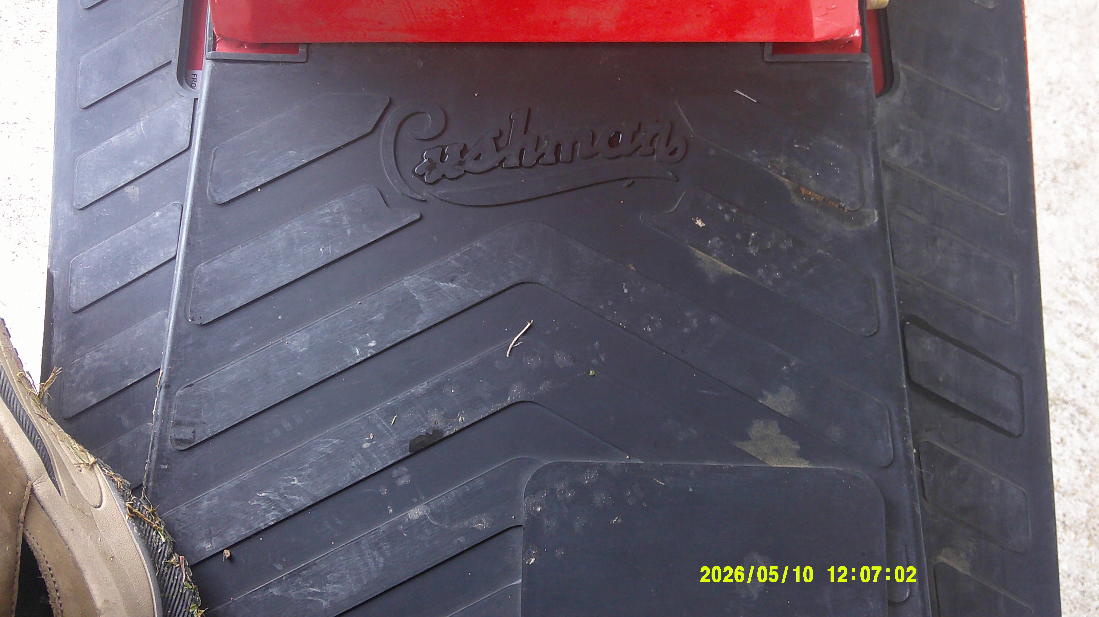 Black floor mat with embossed Cushman logo