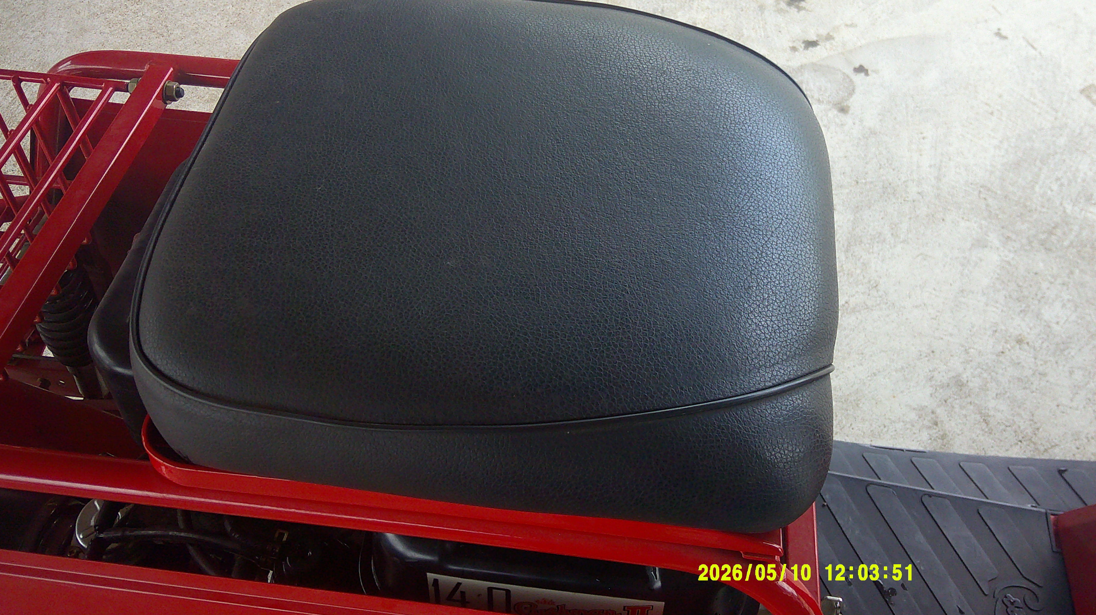 Black textured vinyl seat cushion on red utility vehicle.