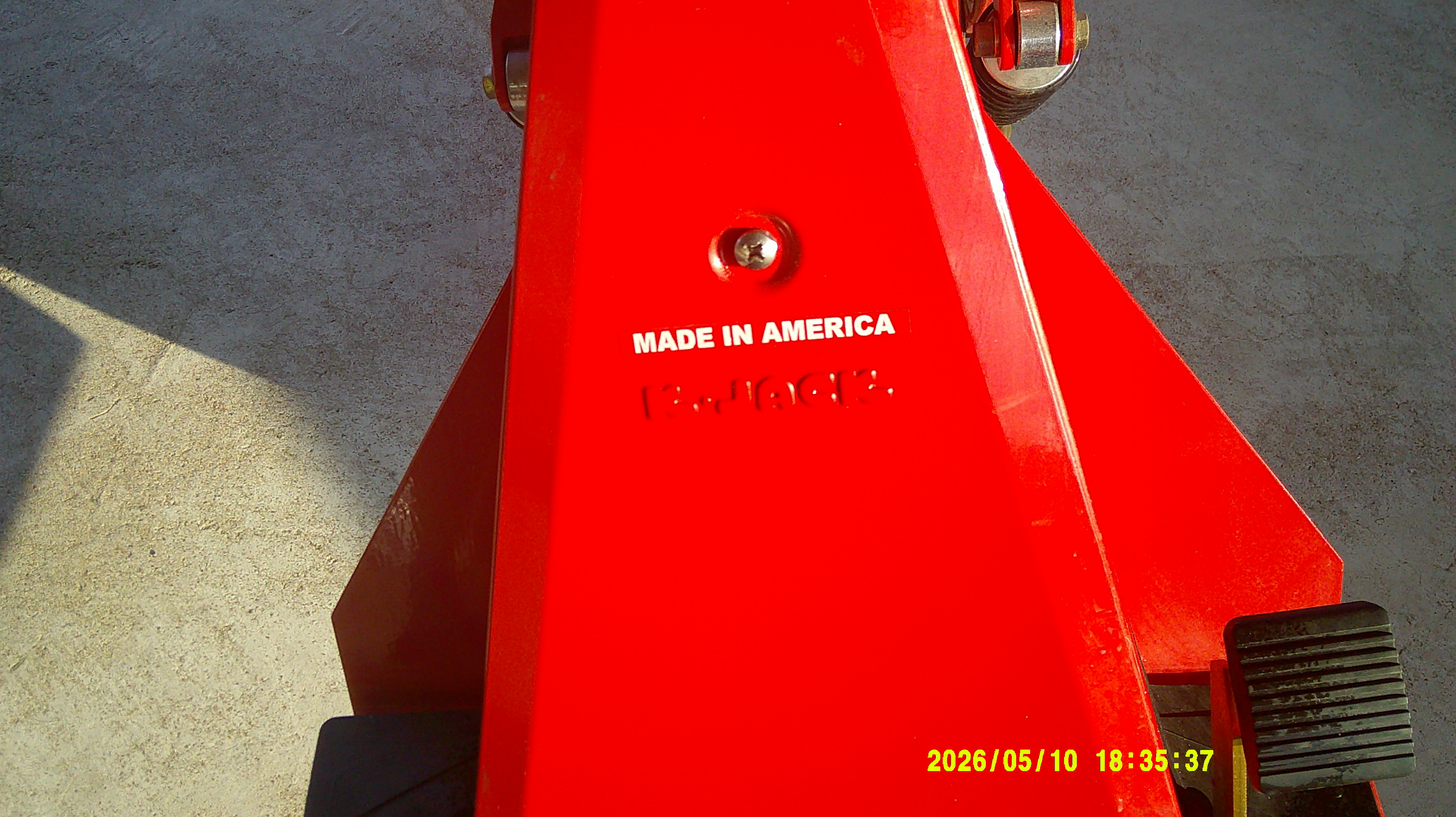 Red hydraulic floor jack detailing with Made in America sticker