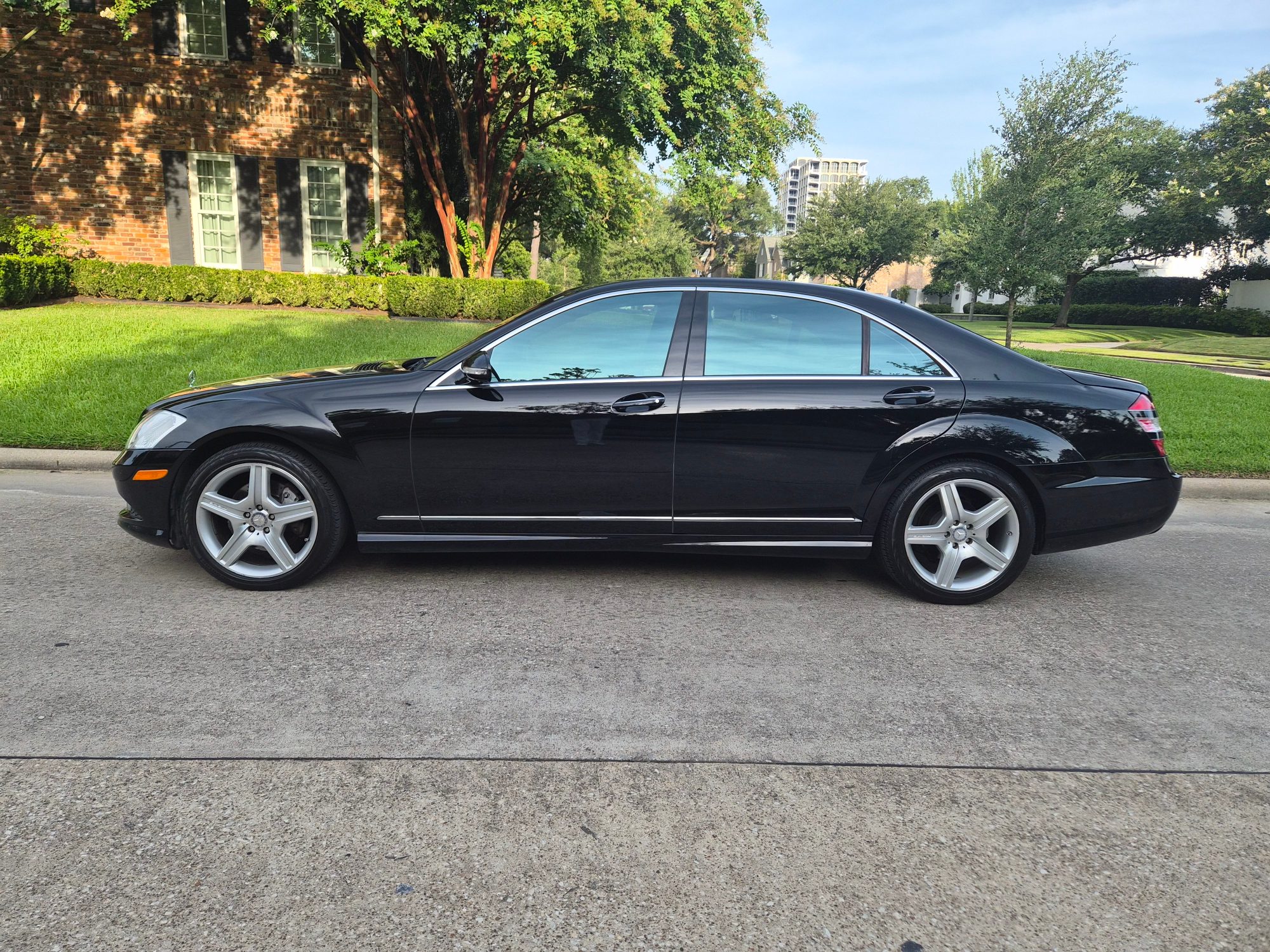 Full profile view of a black Mercedes-Benz S-Class sedan.