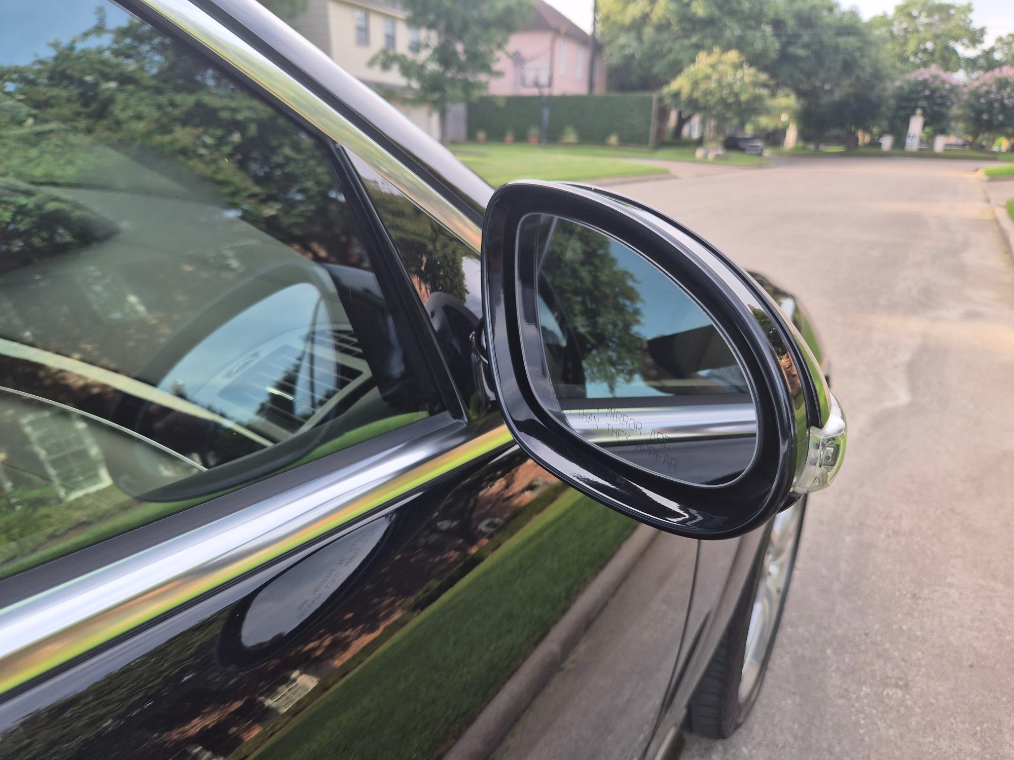 Passenger side view mirror and window trim detail.