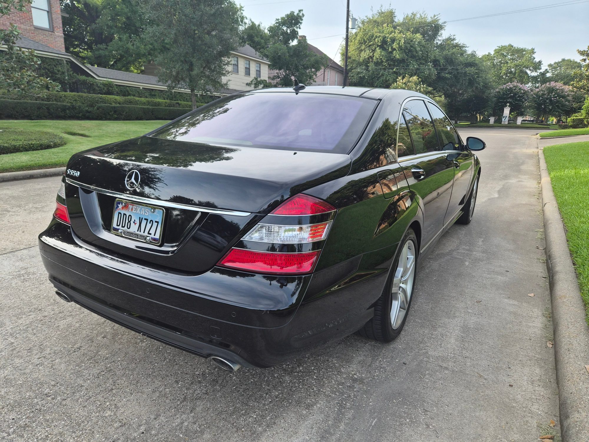 Rear three-quarter view of a black Mercedes-Benz S550 sedan.