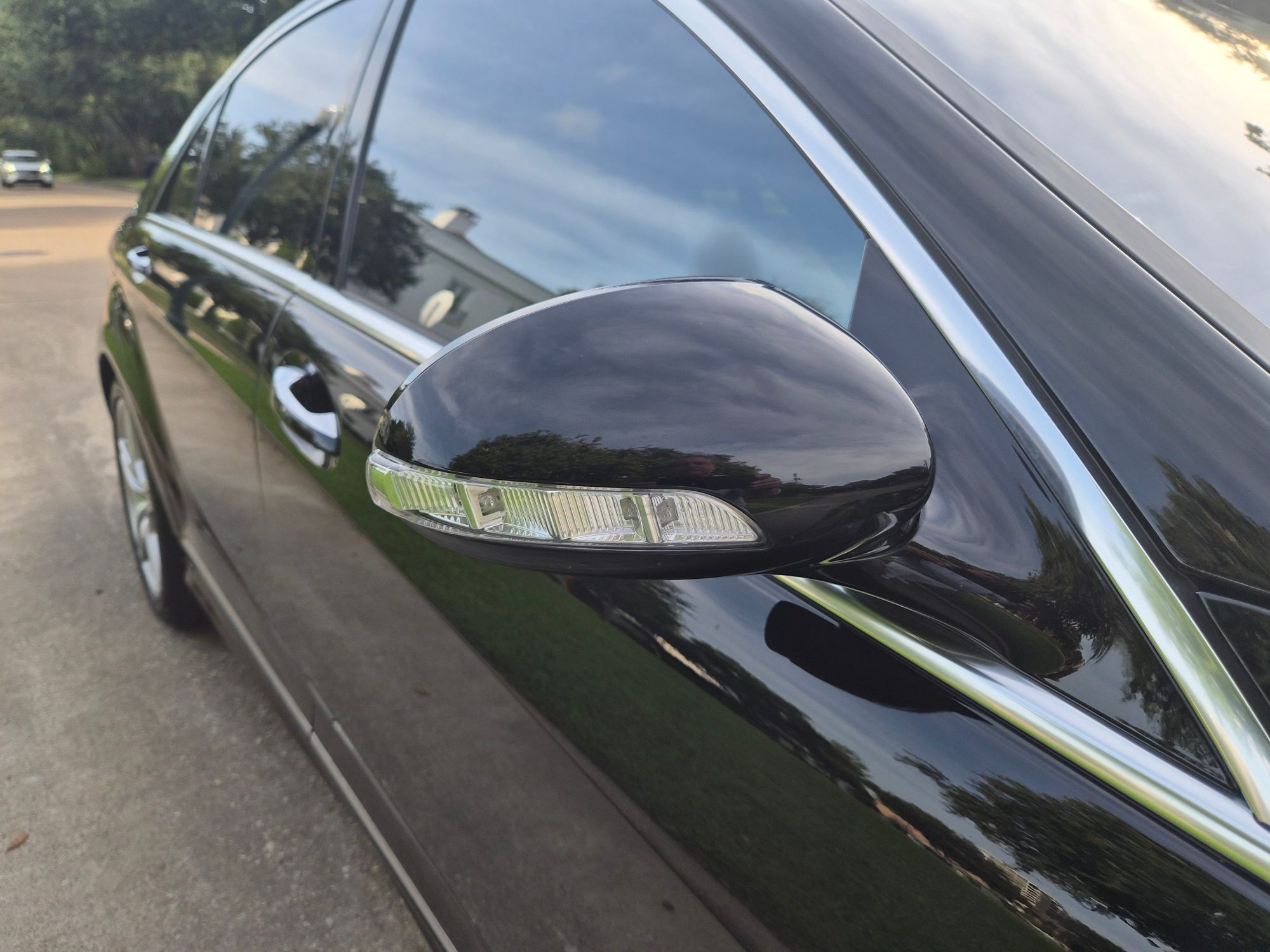 Close-up of driver-side mirror with integrated turn signal.