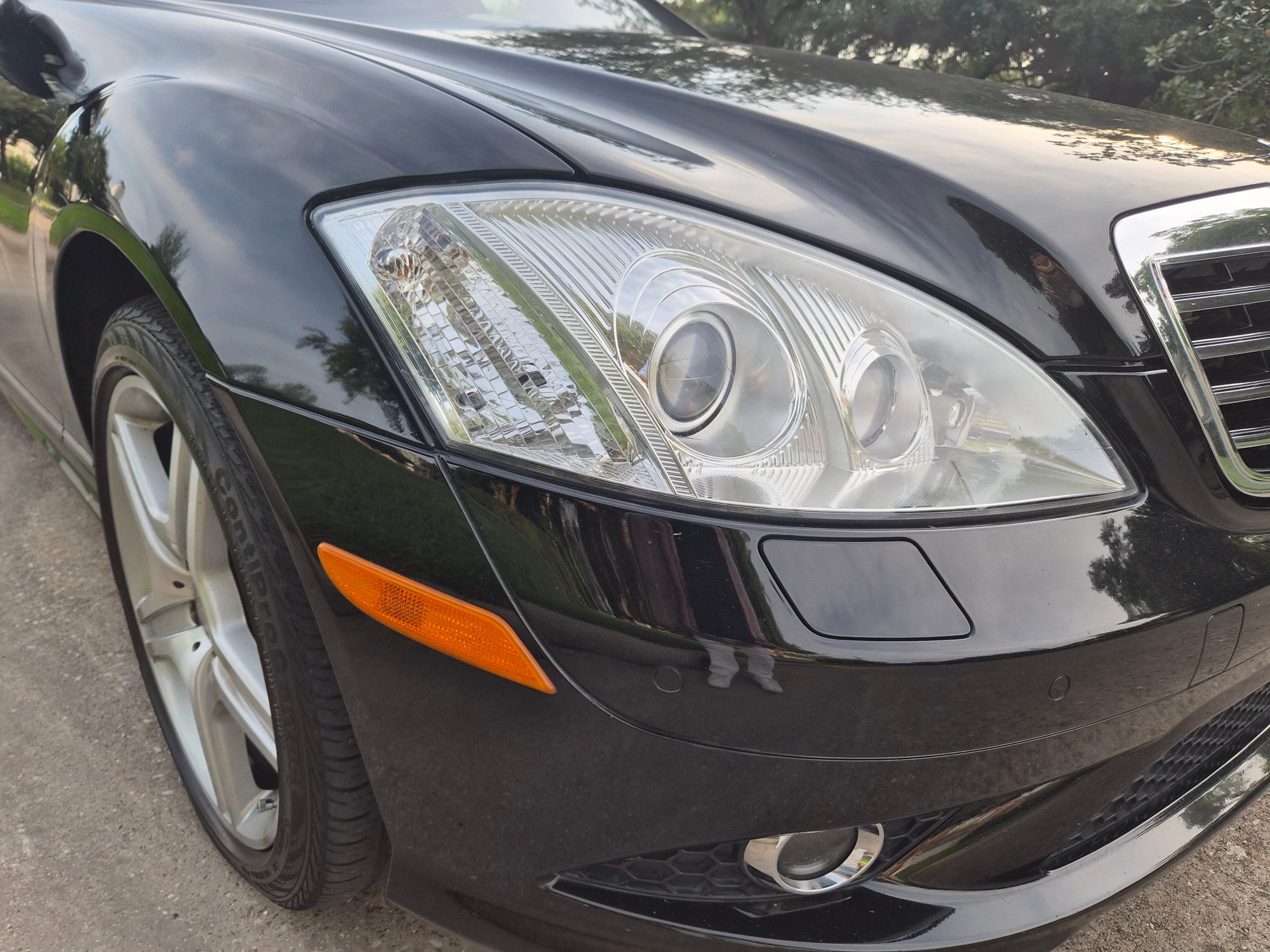 Close-up of the front driver-side headlight and bumper area.