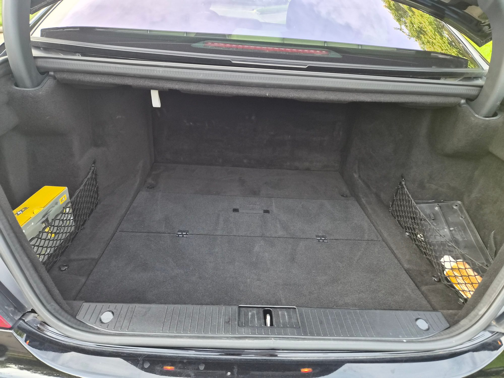 View of the vehicle trunk interior with cargo nets.