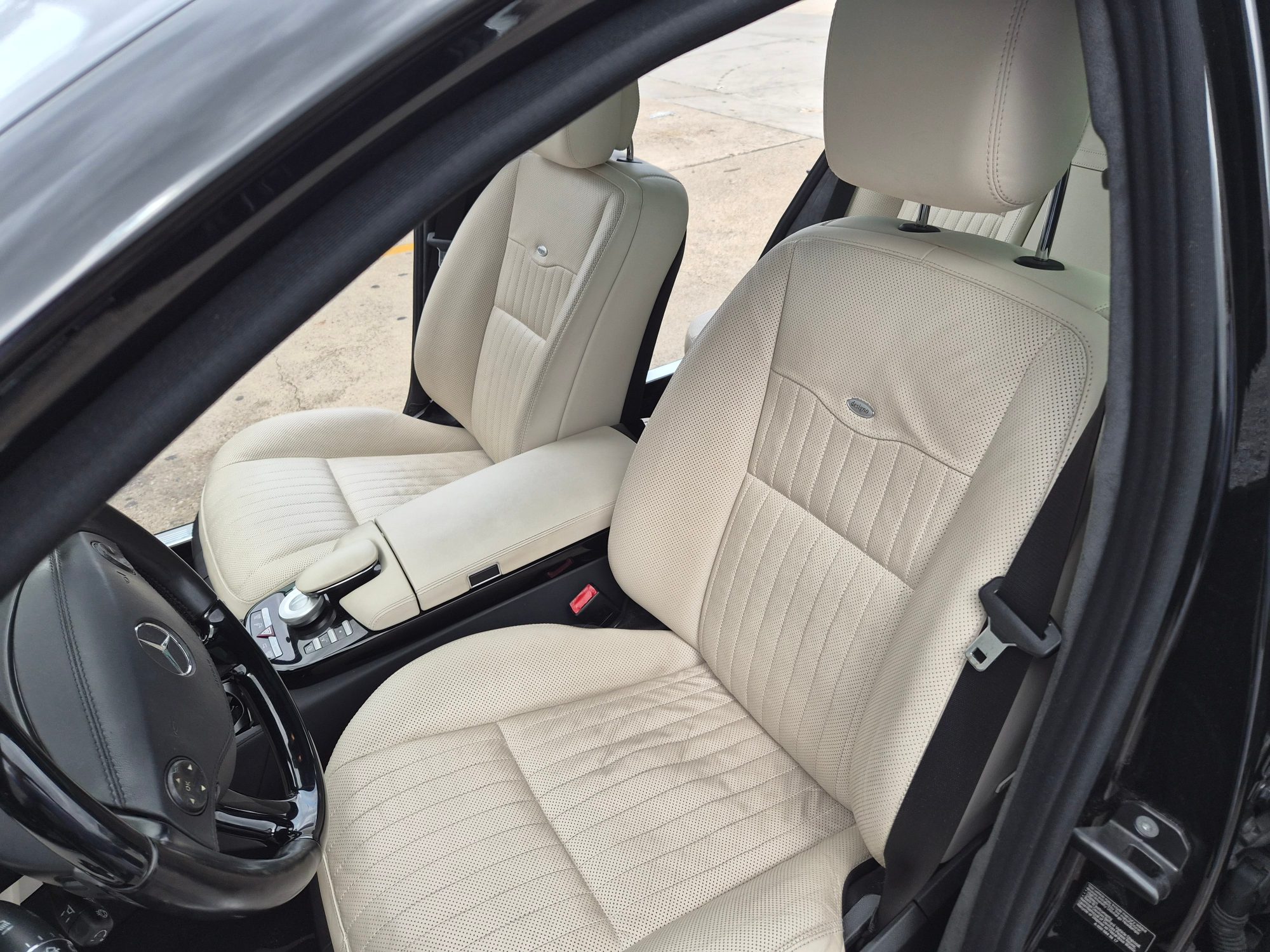 View of the front cabin featuring perforated leather upholstery and center console.