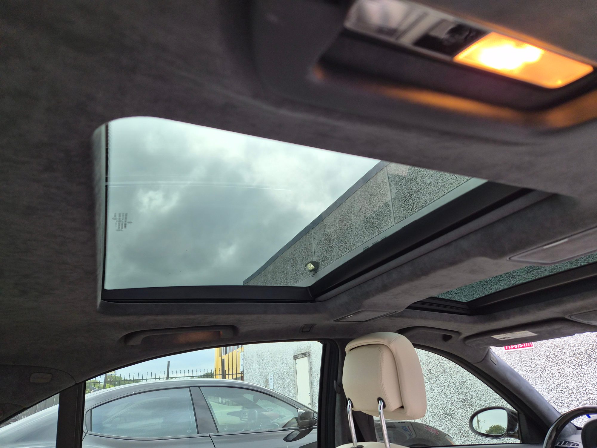 View of the dual panel sunroof and Alcantara headliner from the rear seat.