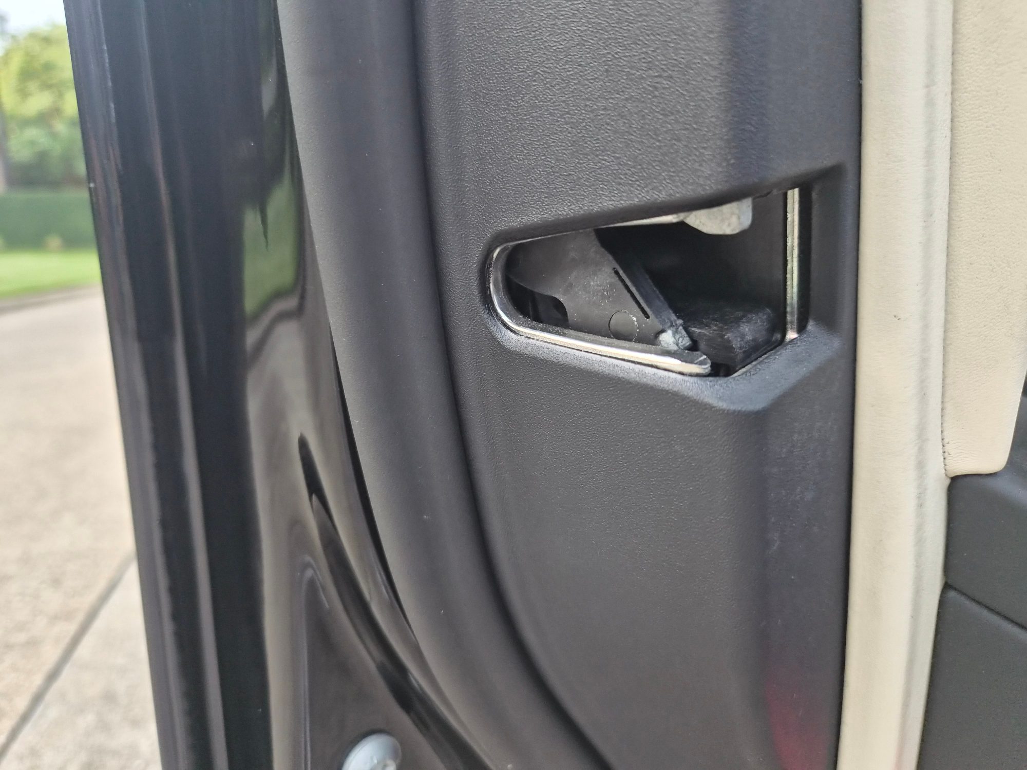Close-up of the door latch mechanism and interior paneling.