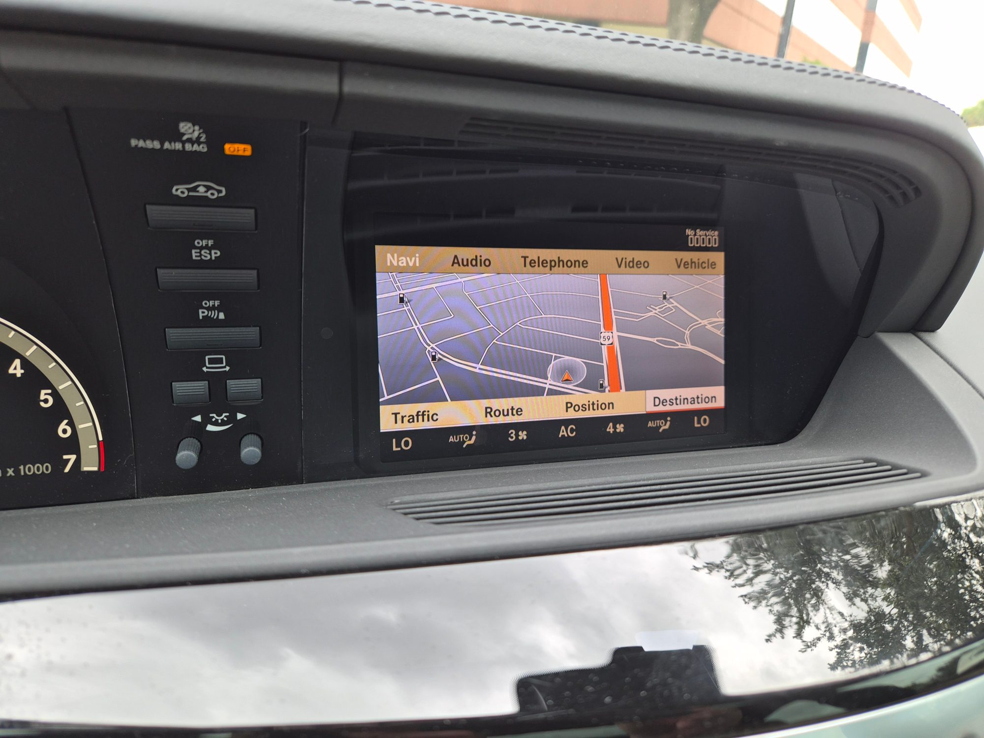 Dashboard infotainment screen displaying navigation system and climate controls.