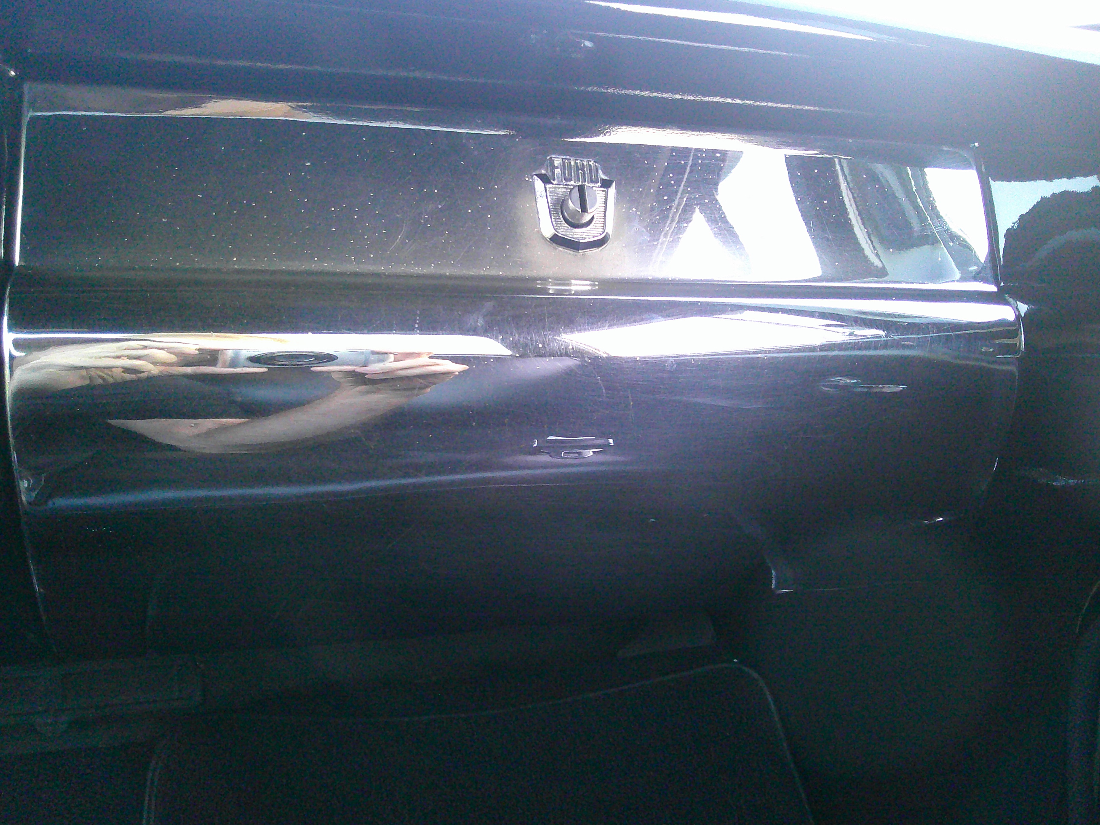 Chrome glove box door with Ford emblem and push-button release
