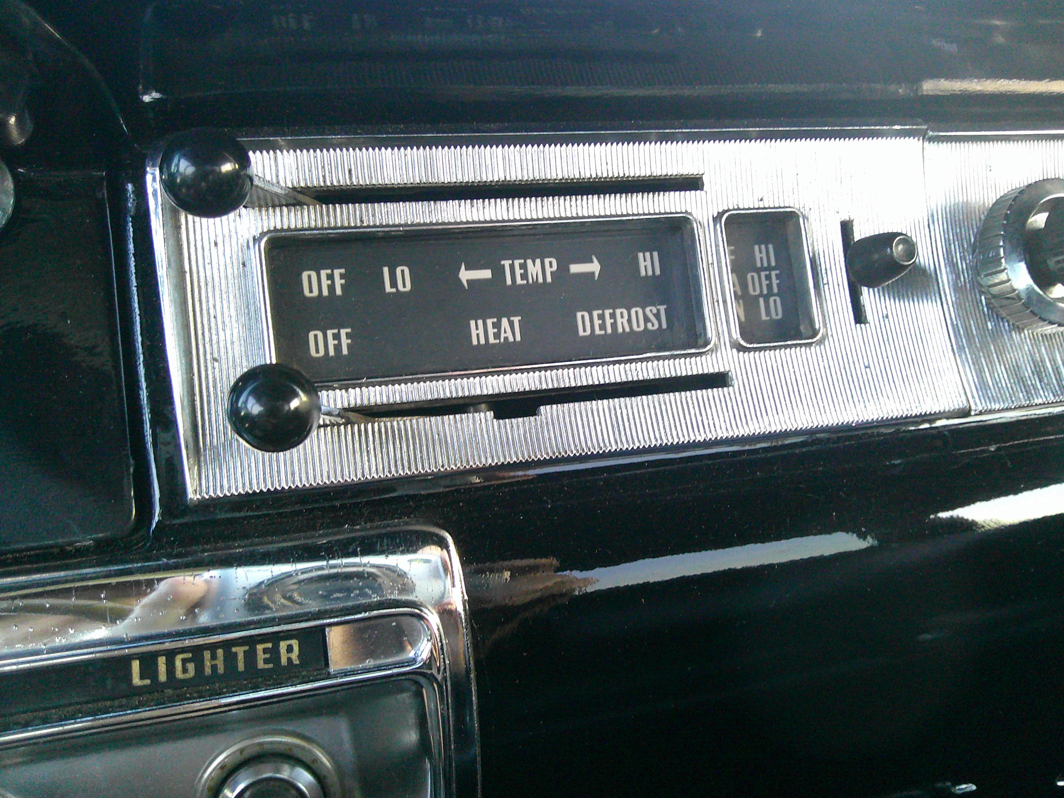 Dashboard climate controls and cigarette lighter