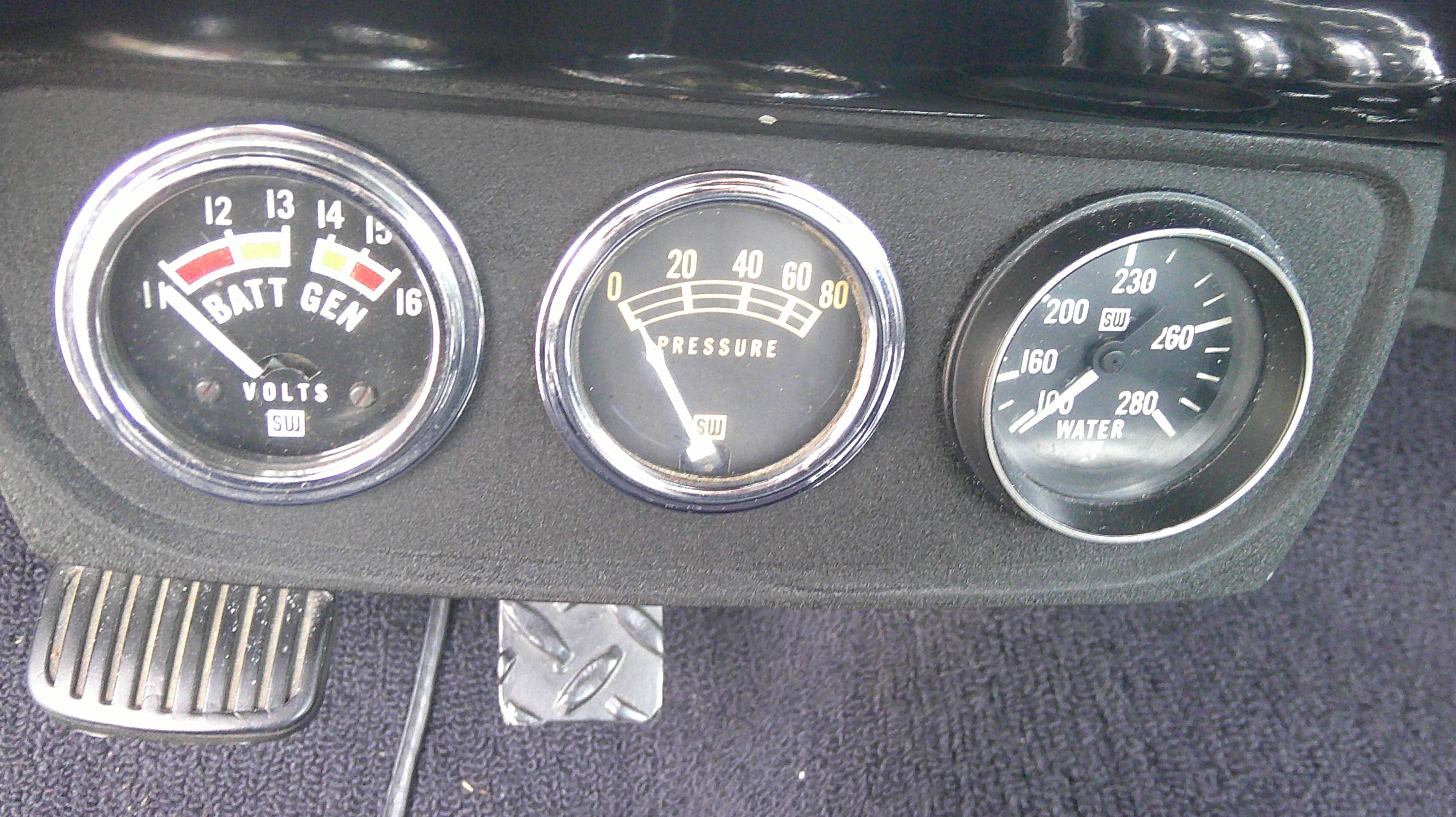 Three-gauge cluster featuring battery, oil pressure, and water temperature