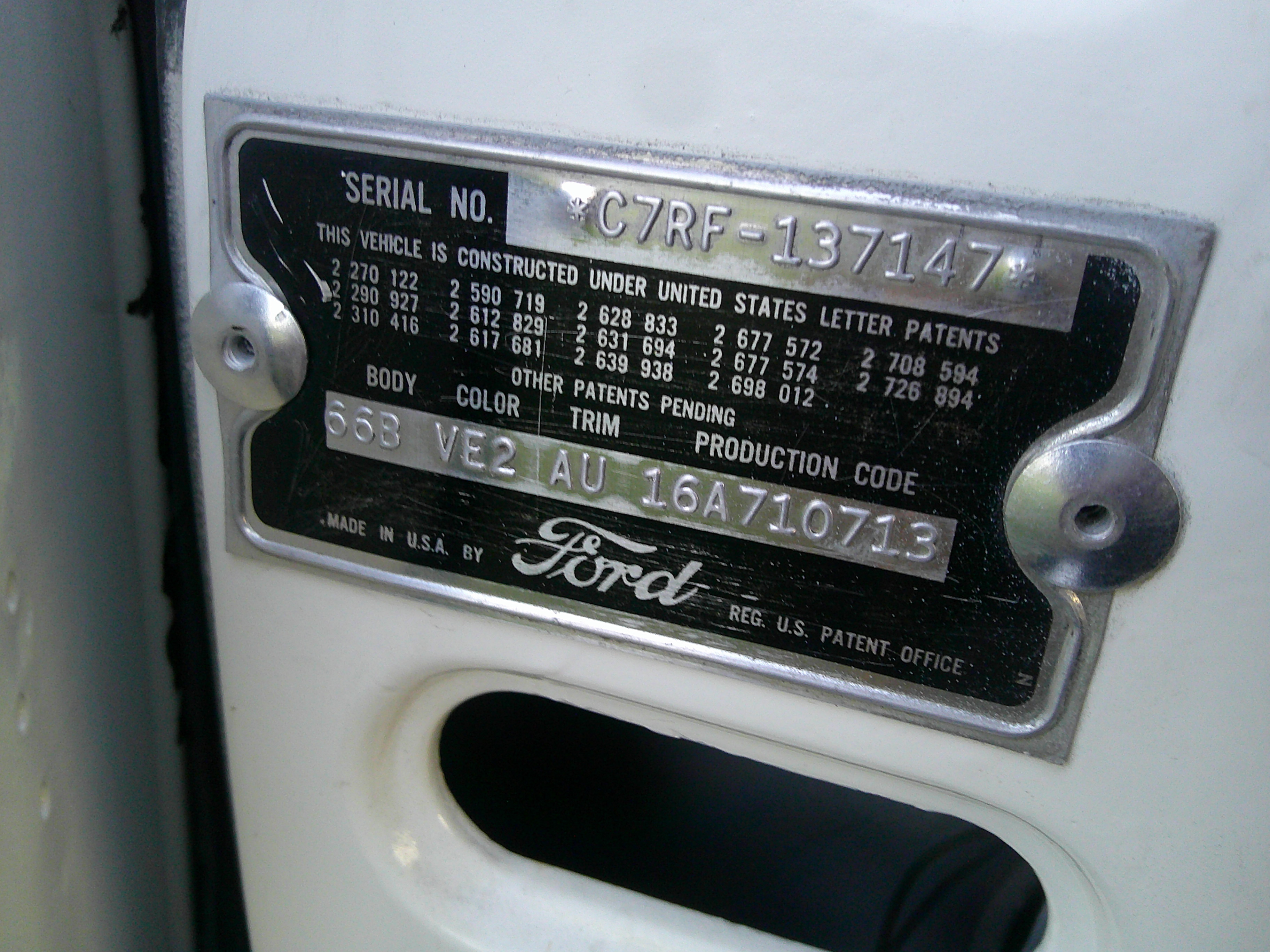 Ford door jamb VIN and data plate showing production codes and serial number.