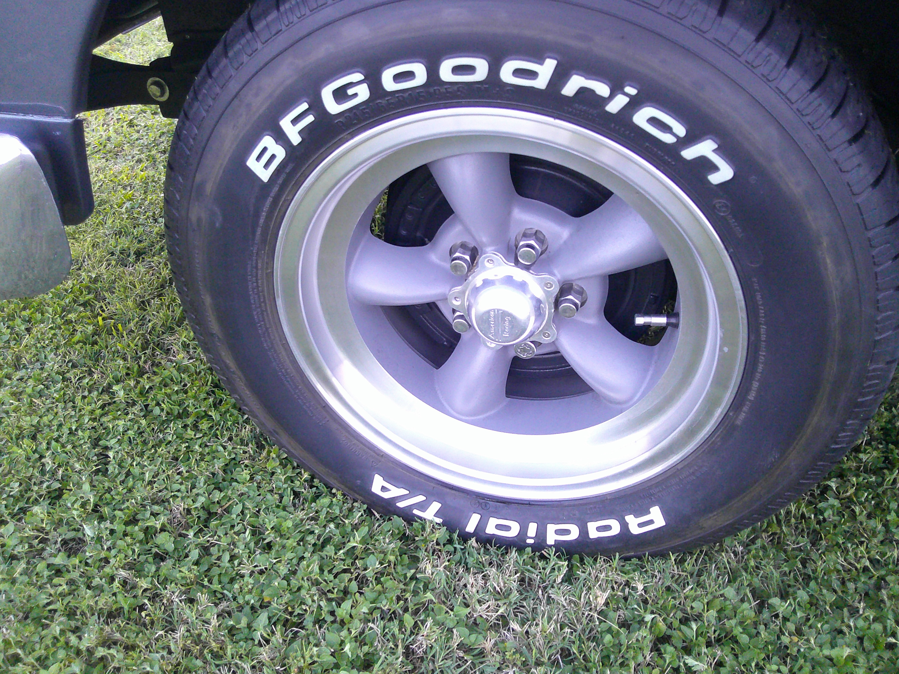 Close-up of BFGoodrich Radial T/A tire on five-spoke alloy wheel.
