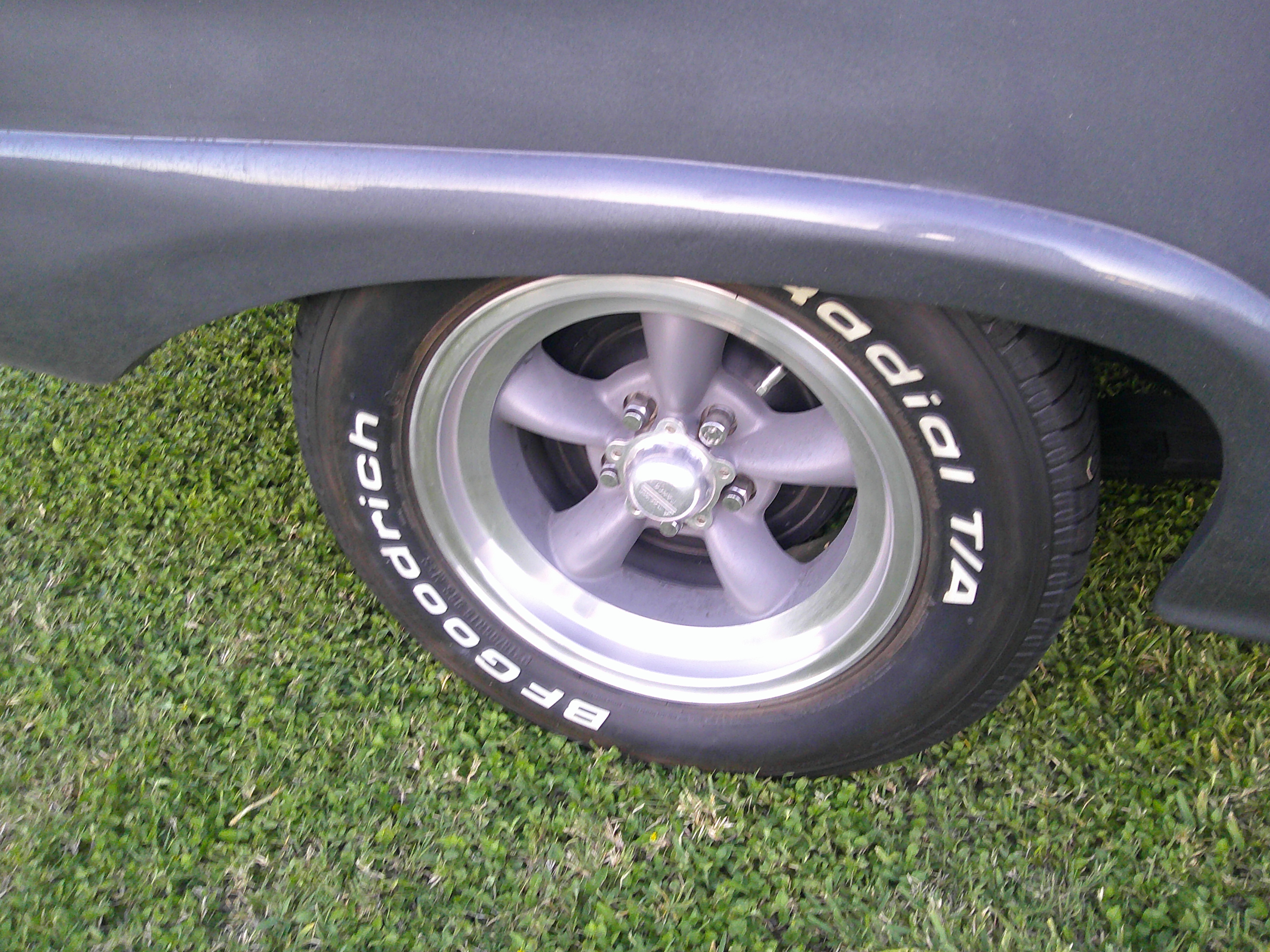 Close-up of rear wheel with BFGoodrich Radial T/A tire and five-spoke rim.
