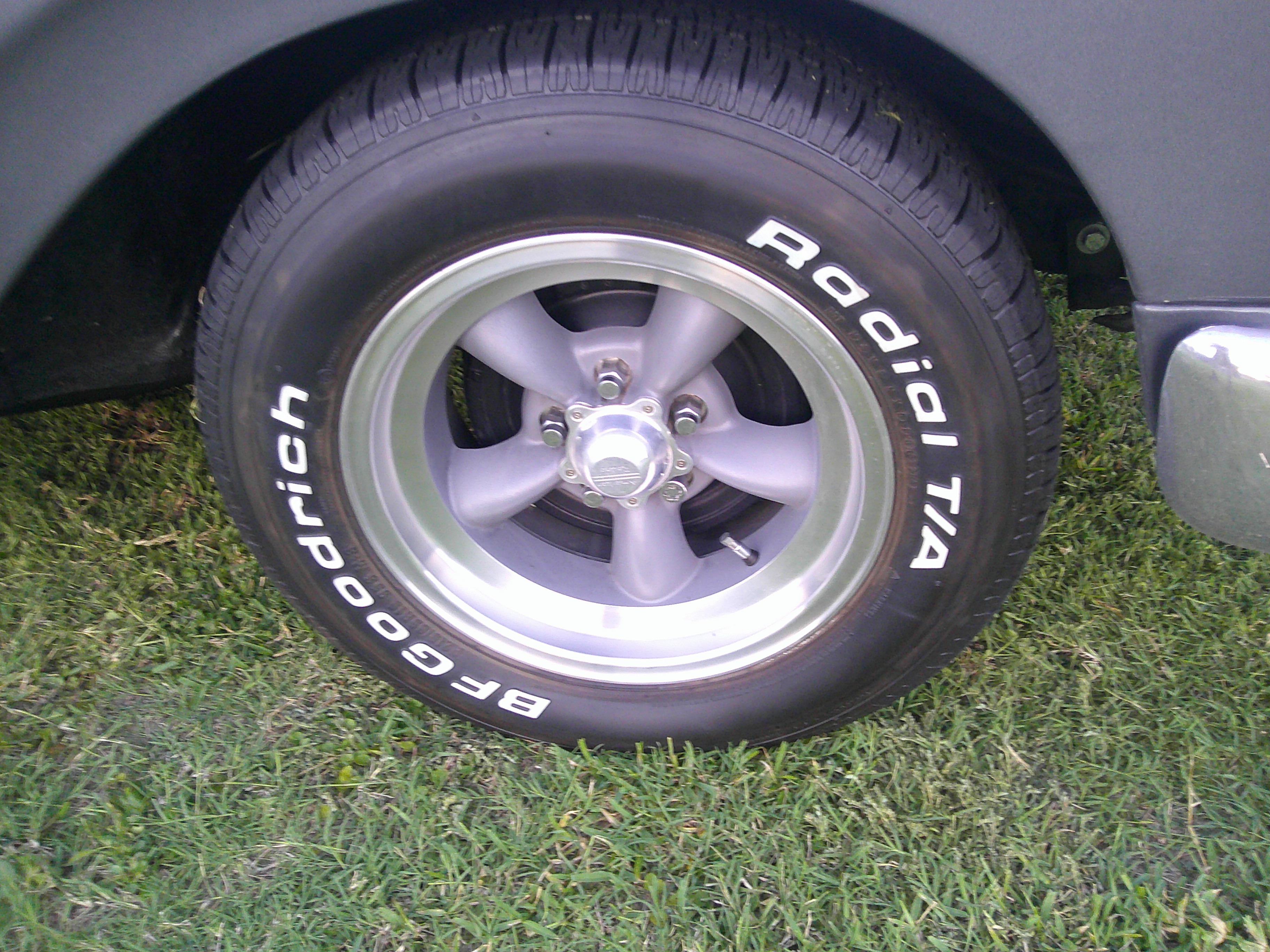 Close-up of five-spoke alloy wheel with BFGoodrich Radial T/A tire.