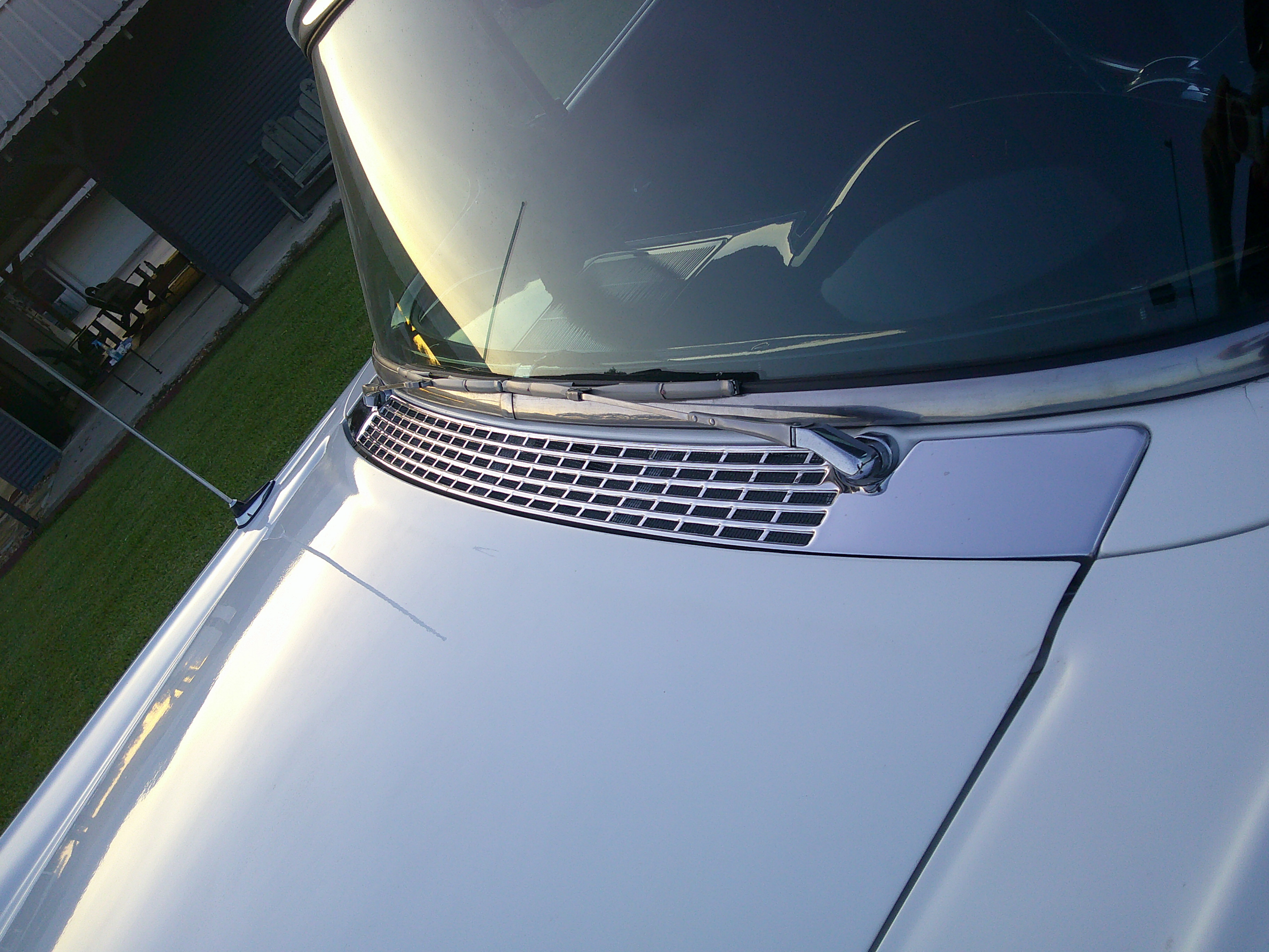 Close-up of the front hood, cowl vent grille, and windshield