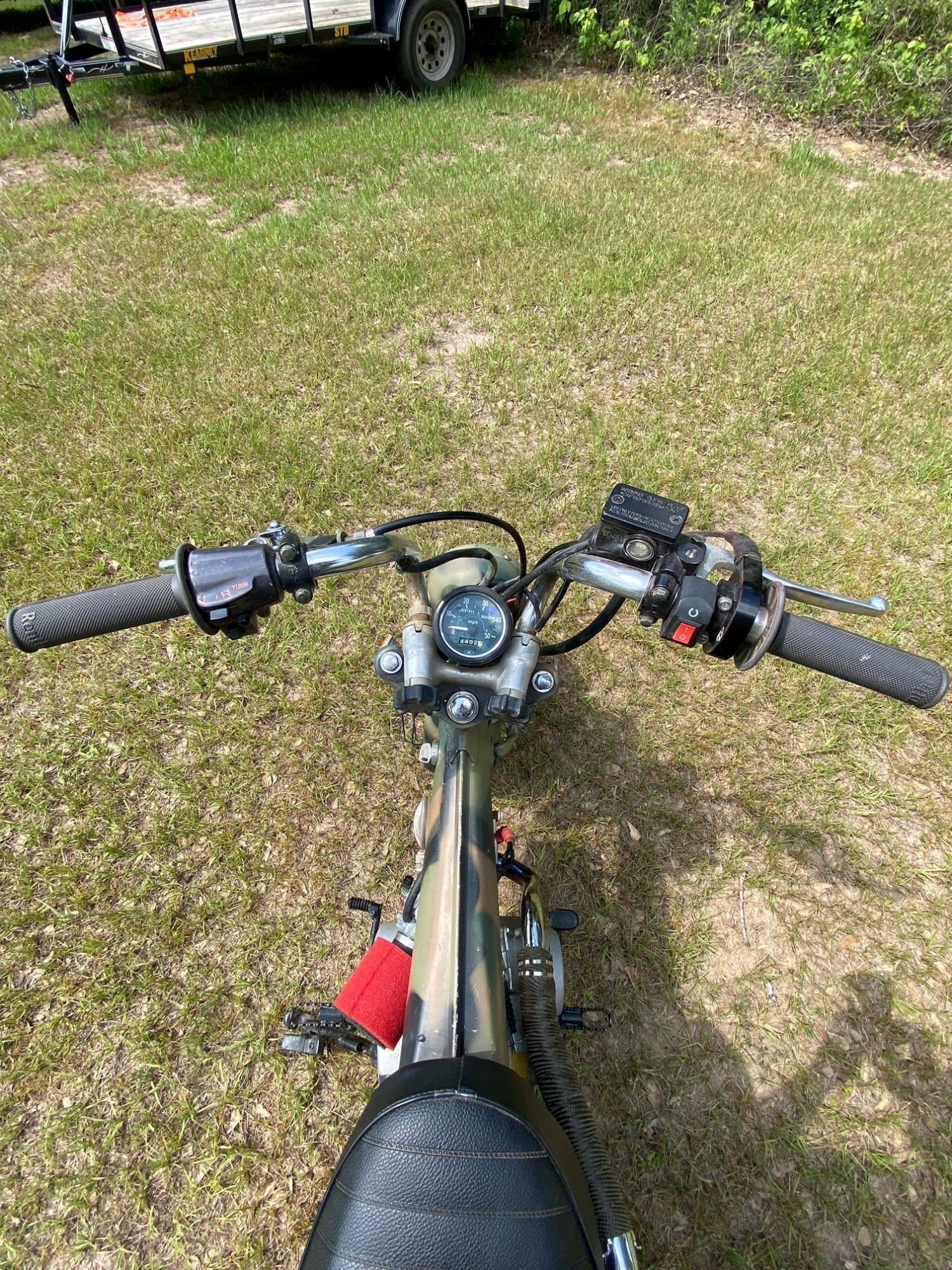 POV view of motorcycle handlebars, speedometer, and controls