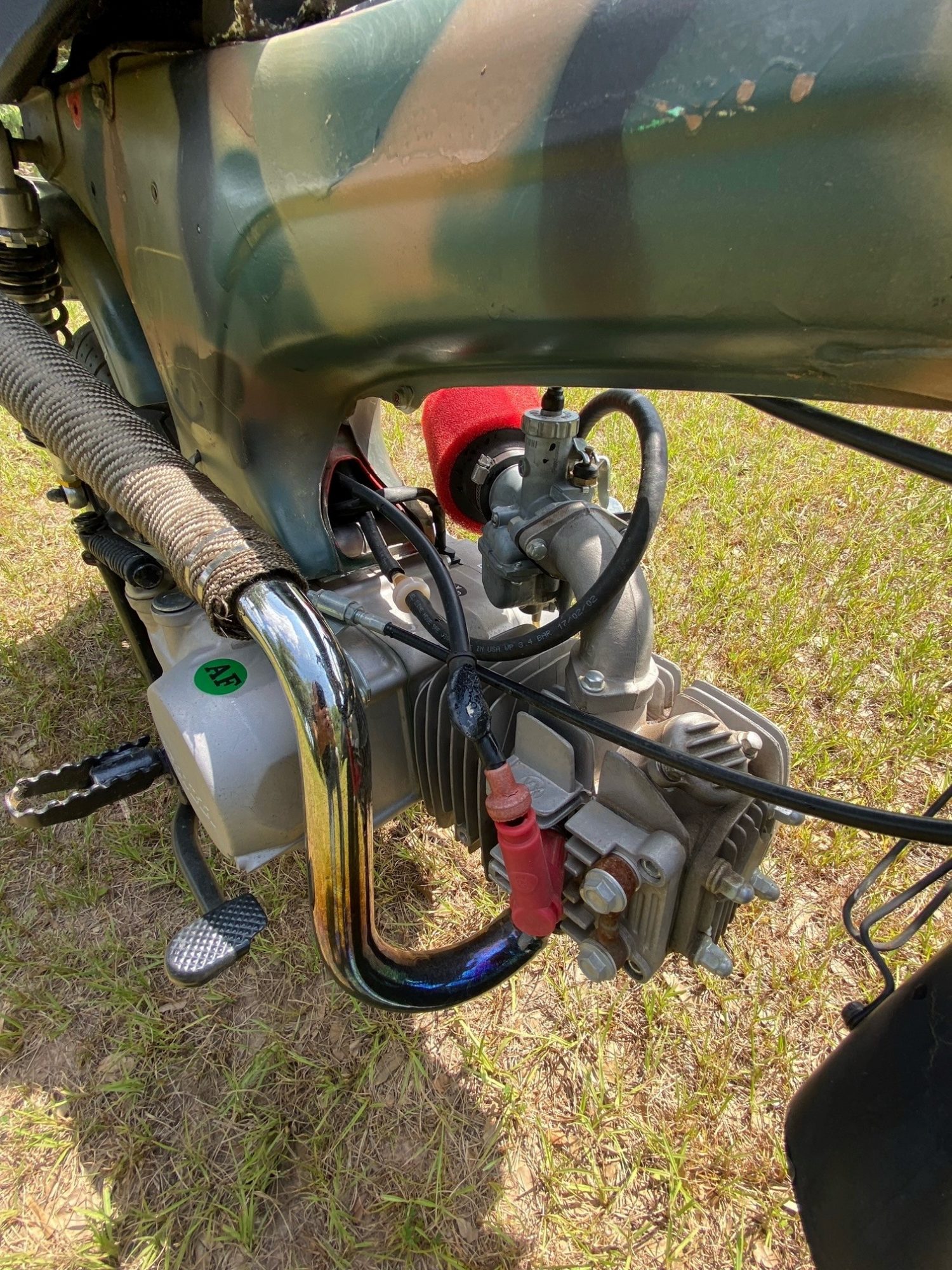 Close-up of the horizontal single-cylinder engine and carburetor assembly.